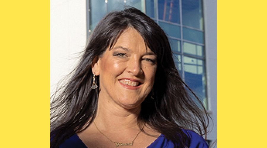 A portrait of a woman smiling at the camera.