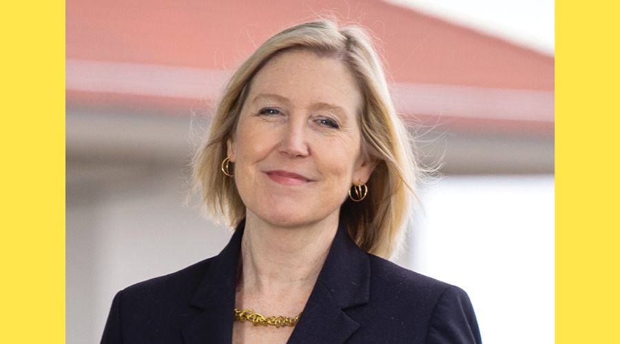 A portrait of a woman smiling at the camera.