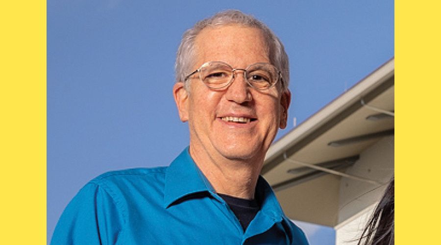 A portrait of a man smiling at the camera.