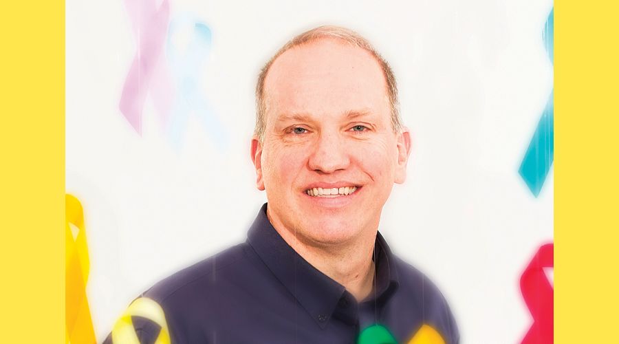 A portrait of a man smiling at the camera.