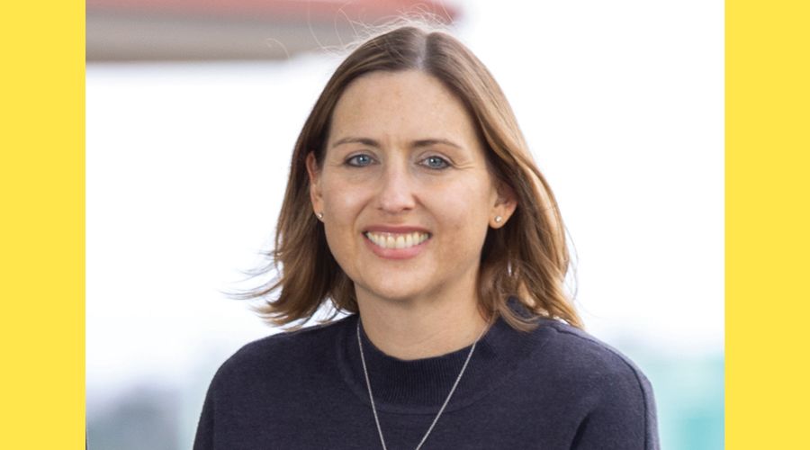 A portrait of a woman smiling at the camera.