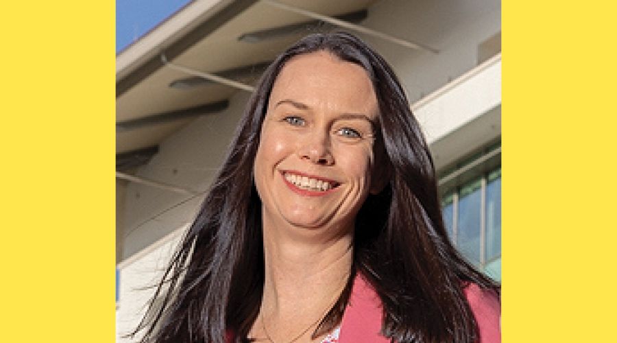 A portrait of a woman smiling at the camera.