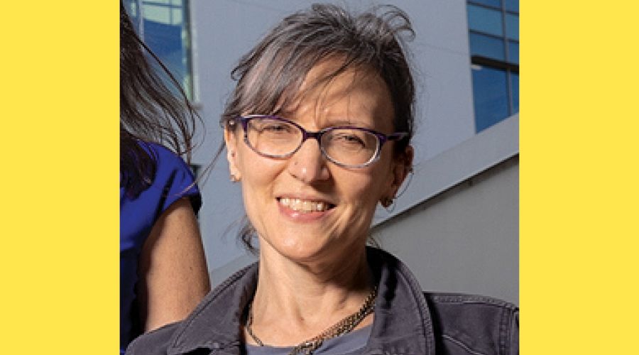 A portrait of a woman smiling at the camera.
