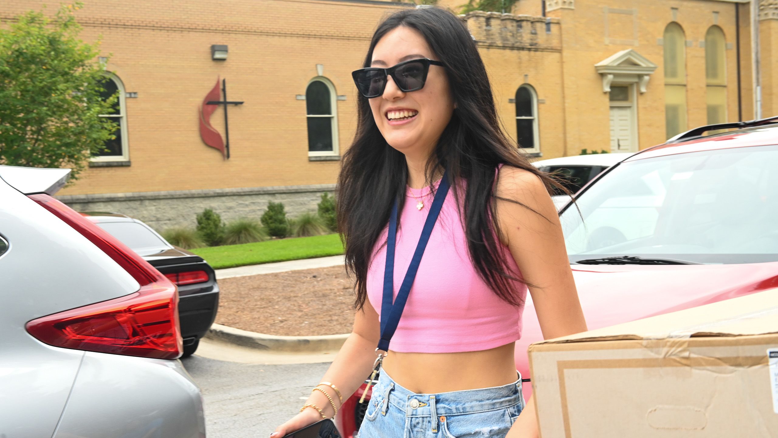 Excited student unpacking her car.