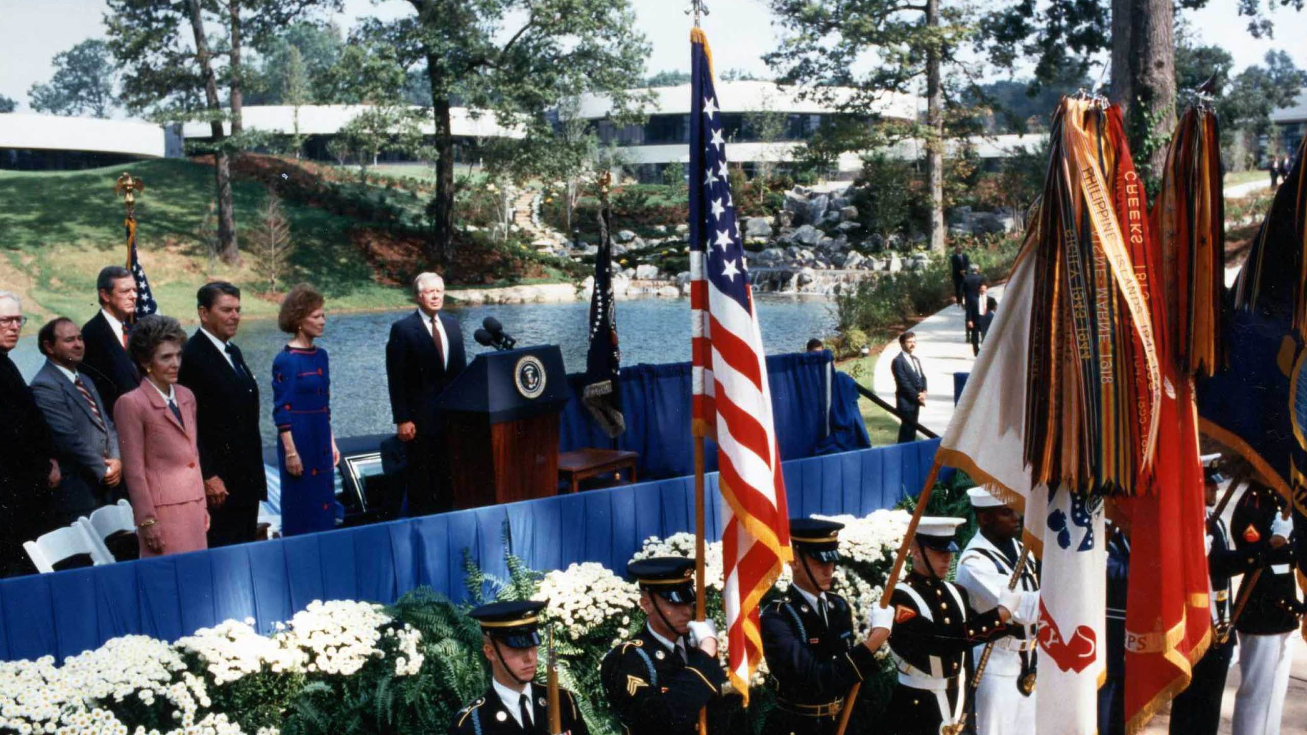 The Carter Center dedication showing a stage on which are President and Mrs. Carter as well as President and Mrs. Reagan