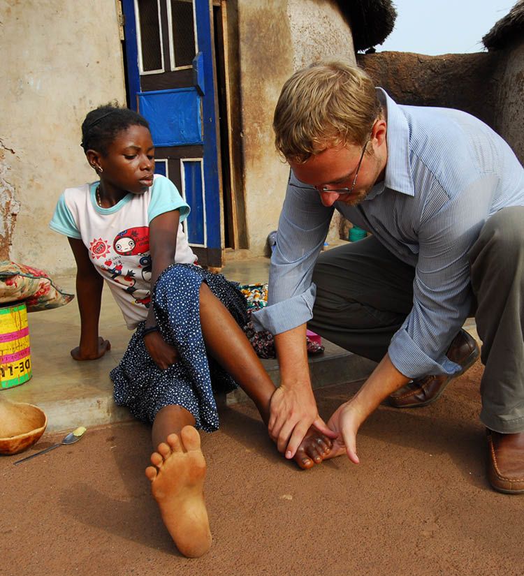 Adam Weiss tending to an African girl with Guinea worm infection