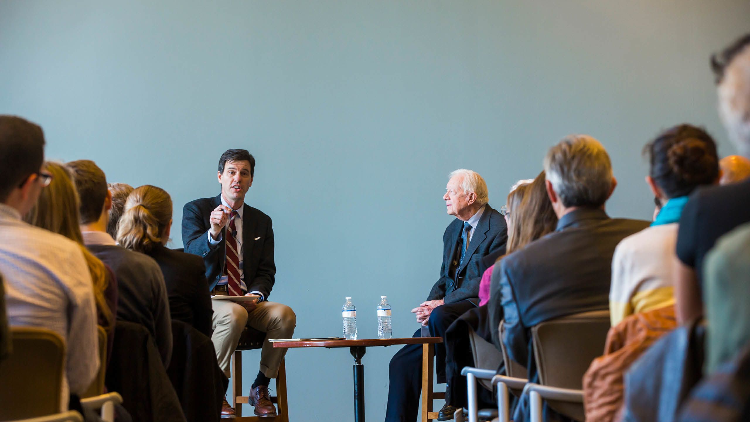 Professor Joseph Crisping and President Carter in conversation with an audience looking on