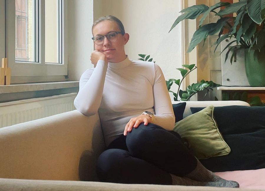 Photo of Claire Pomykala sitting on a couch.