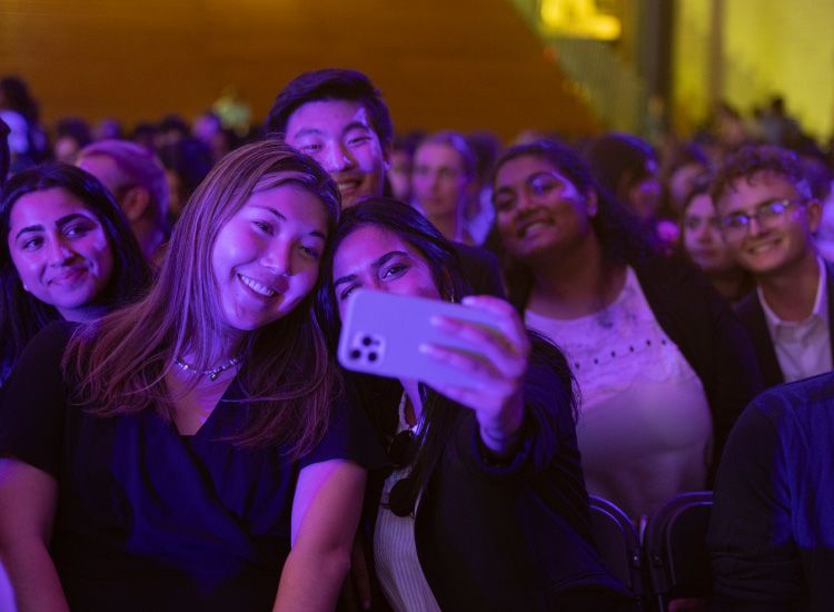 Students pose for a selfie at the 2022 Carter Town Hall, where soccer star and social justice advocate was guest speaker.