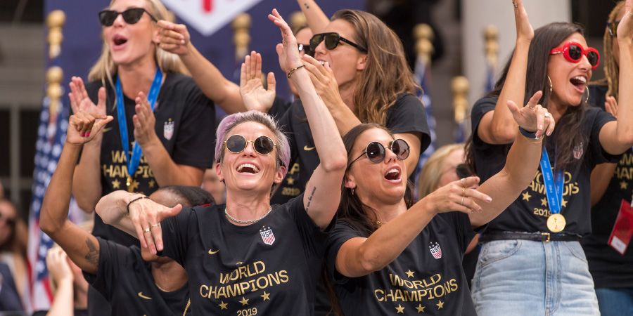 Megan Rapinoe, Alex Morgan and teammates of the United States Women's National Soccer team clap during a celebration of their fourth World Cup championship at City Hall on July 10, 2019 in New York, NY. The ceremony followed a ticker tape parade down the Canyon of Heroes on Broadway.