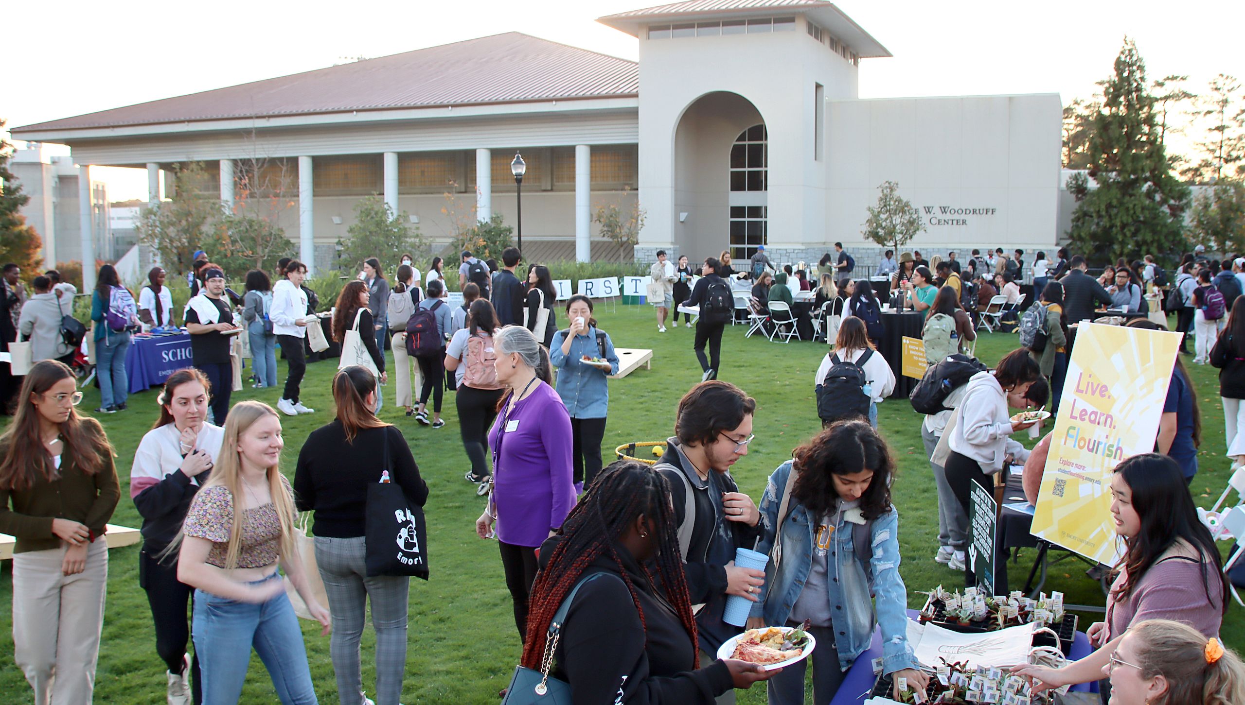 Students gather in front of the Woodruff PE Center to visit tables