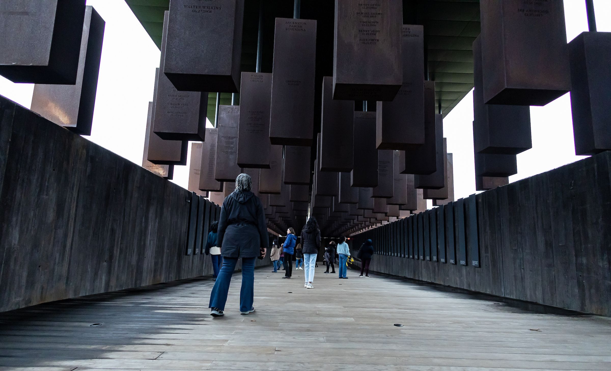 Students look up at steel beams at the National Peace and Justice Memorial, which honors those who lost their lives to racial terror lynchings. 