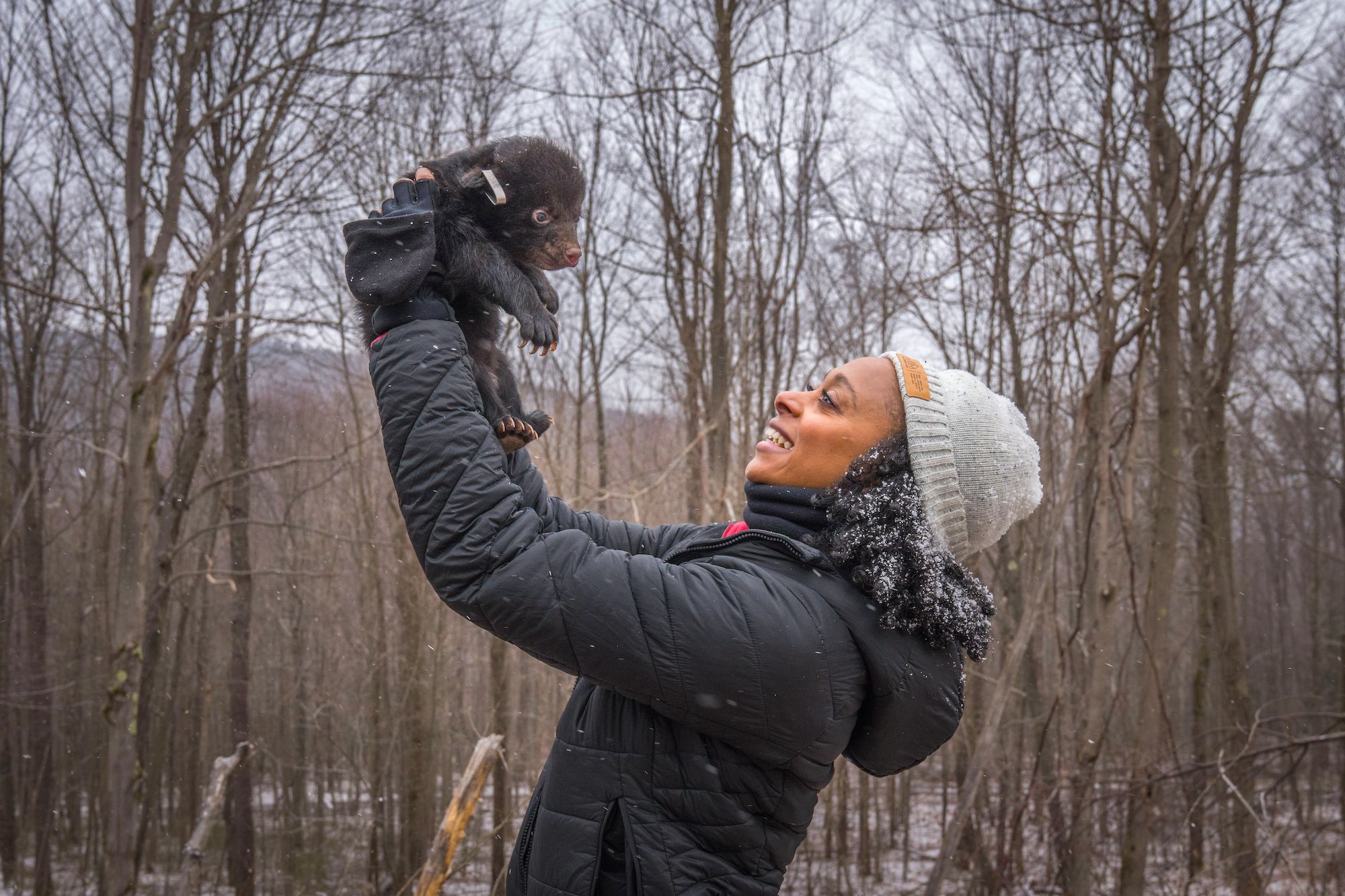 Rae Wynn-Grant holds a bear cub
