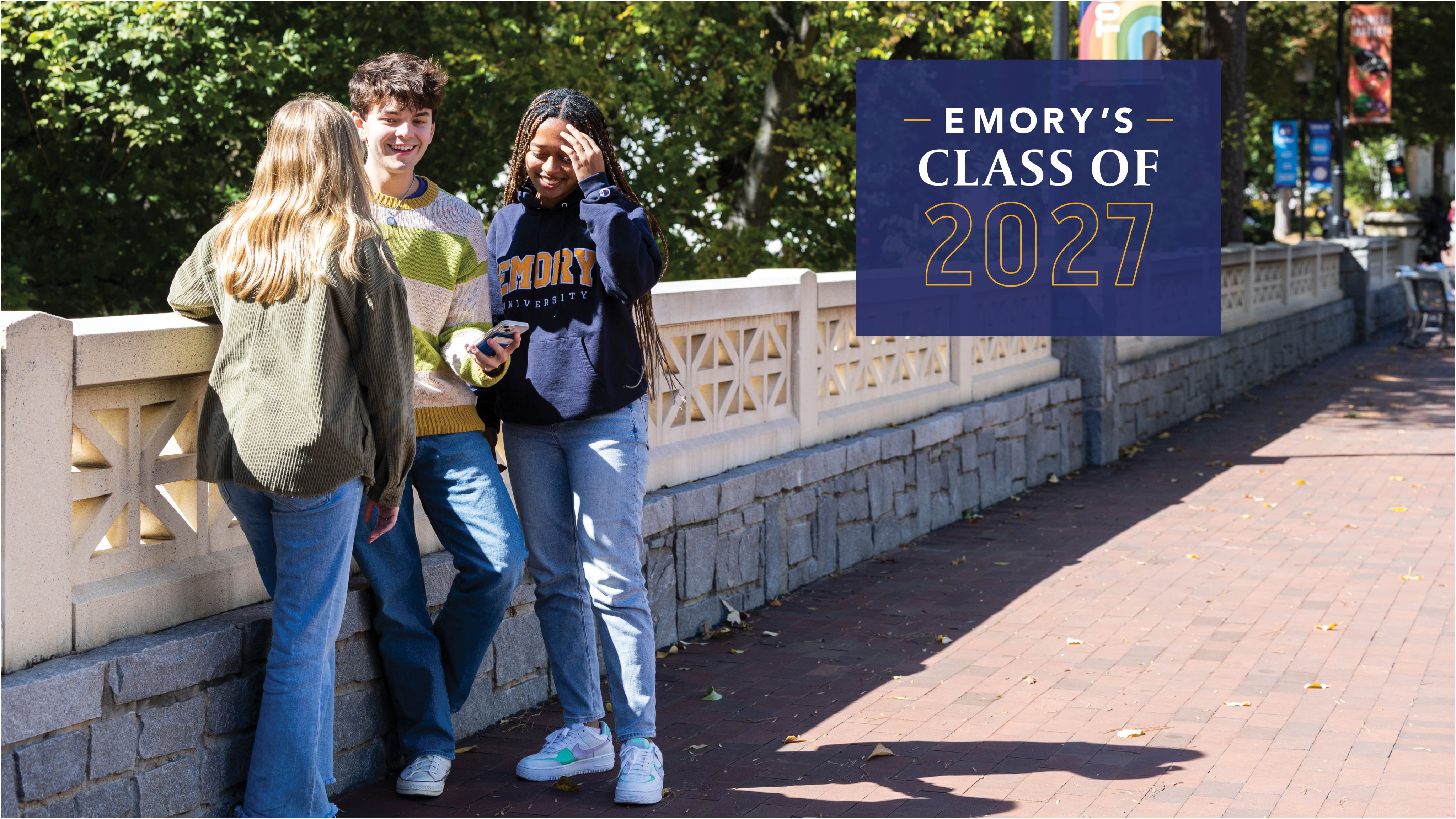Emory's Class of 2027 with background photo of two students walking on a sidewalk