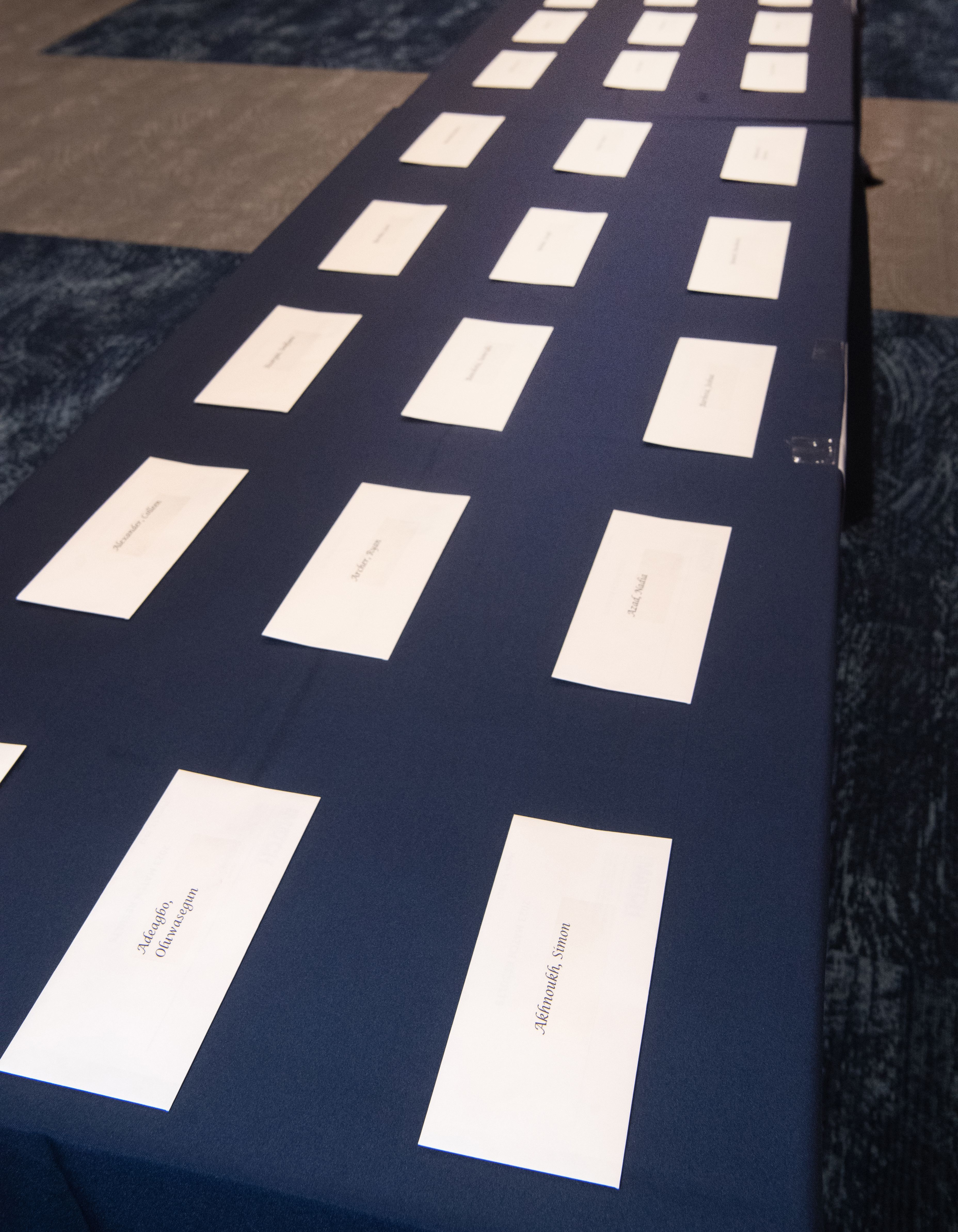Envelopes lined up on a blue table