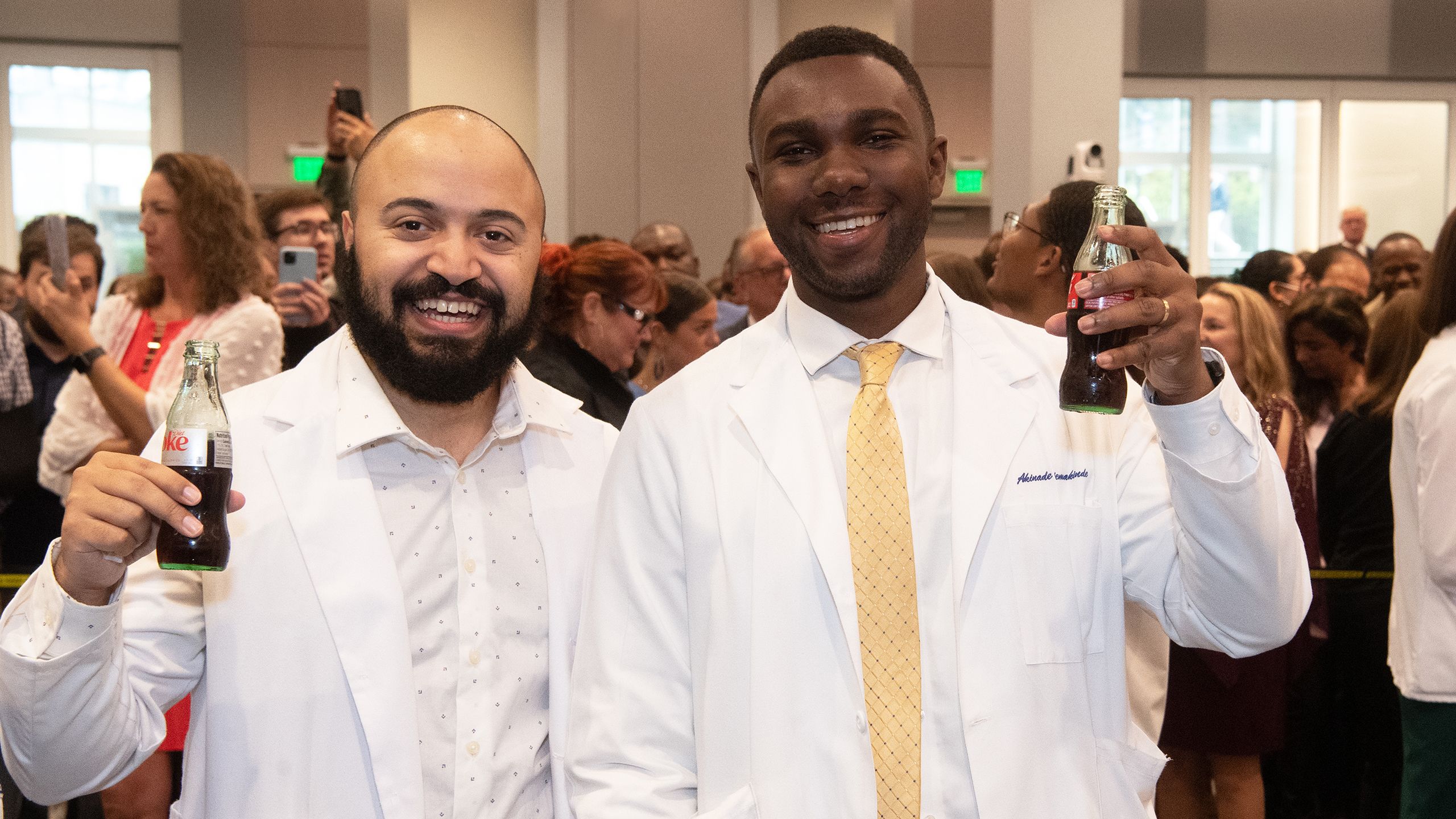Two med students with Coke bottles