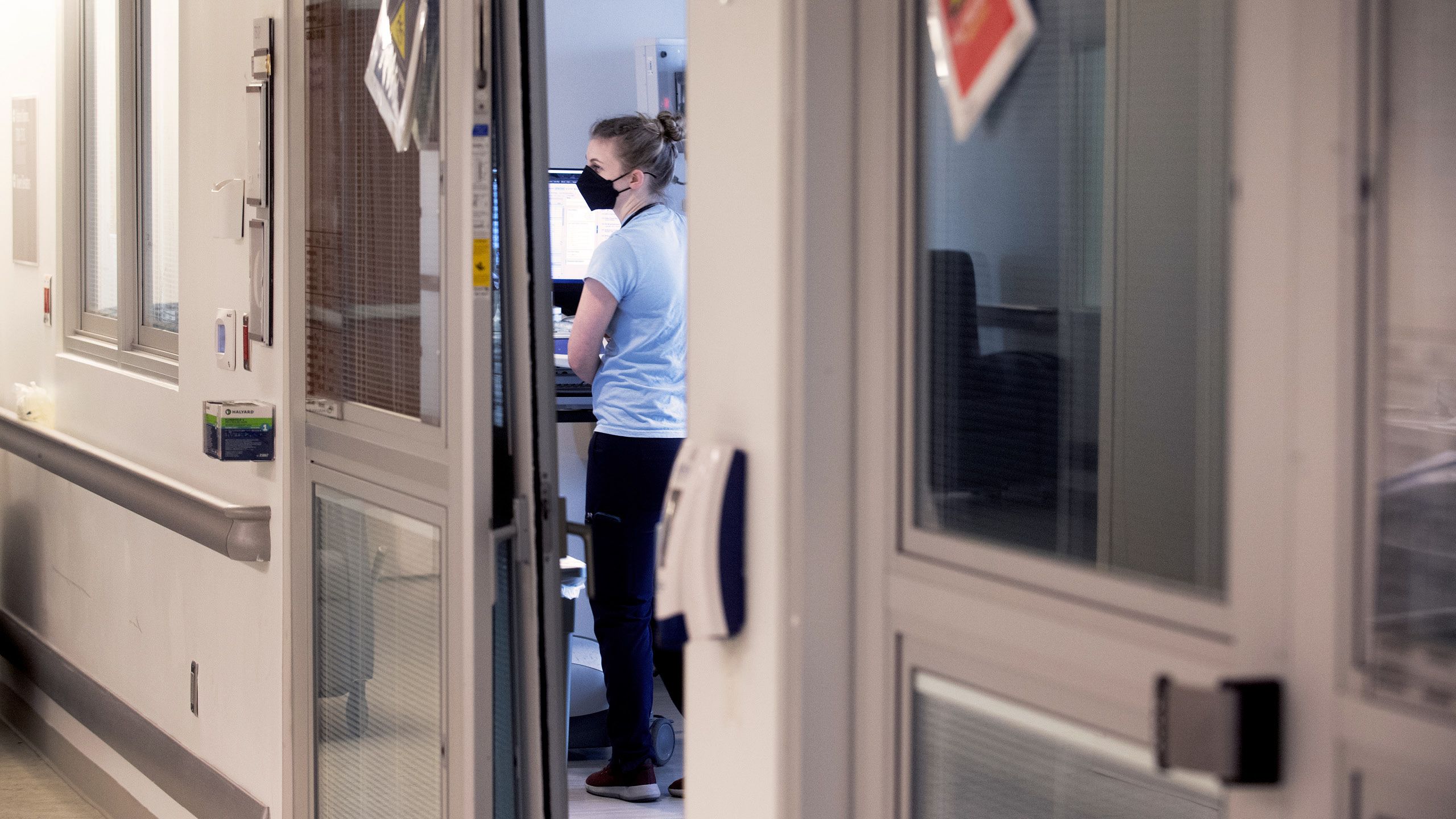 A healthcare worker in a patient room at an Emory Healthcare critical care unit.
