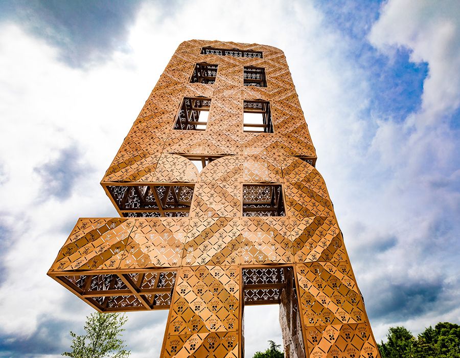 An imposing shot, from the ground level up, of the 30-foot, gold "FREED" sculpture