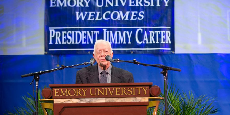 President Jimmy Carter stands behind an Emory University podium at a previous Carter Town Hall event.