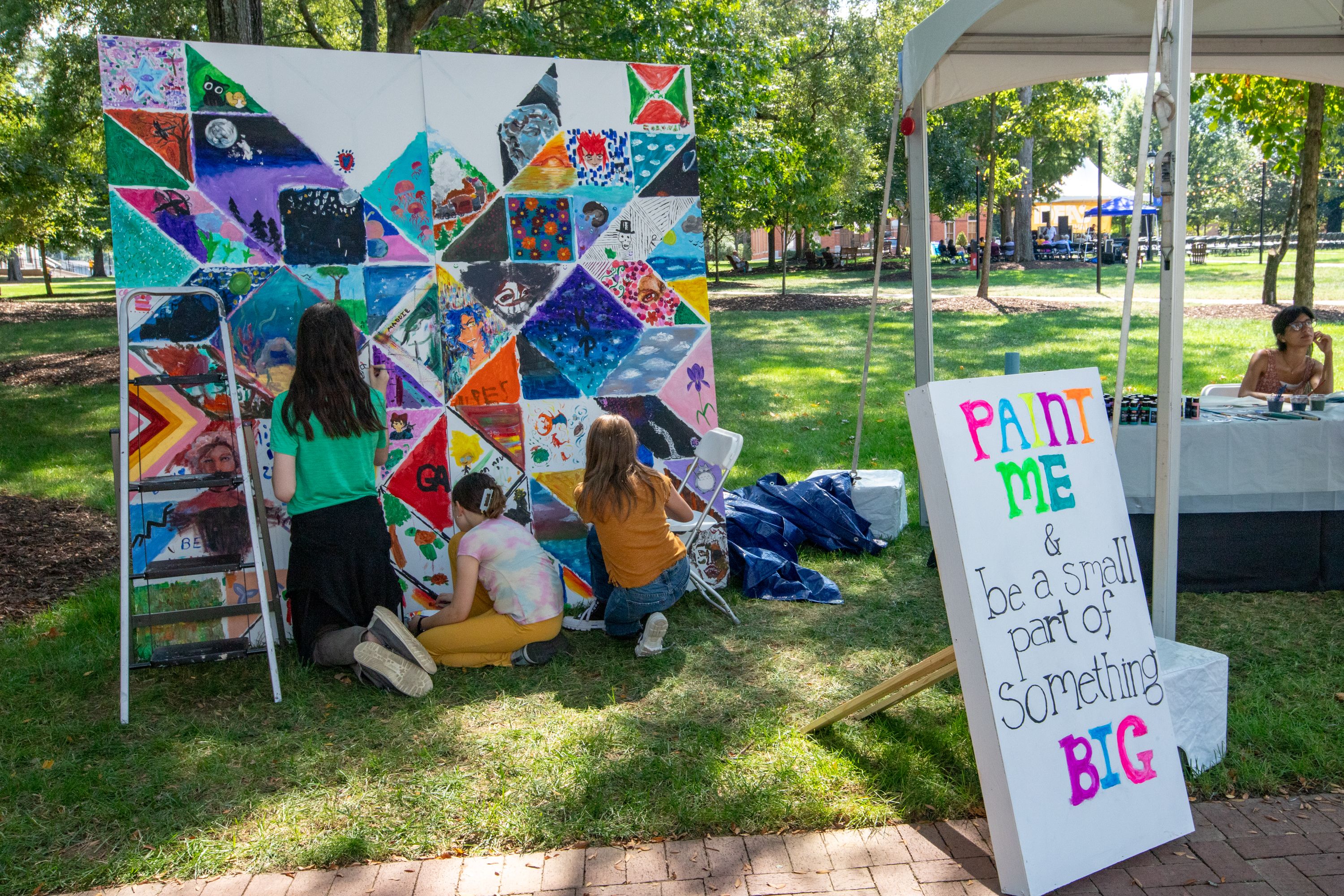 children participating in group painting project