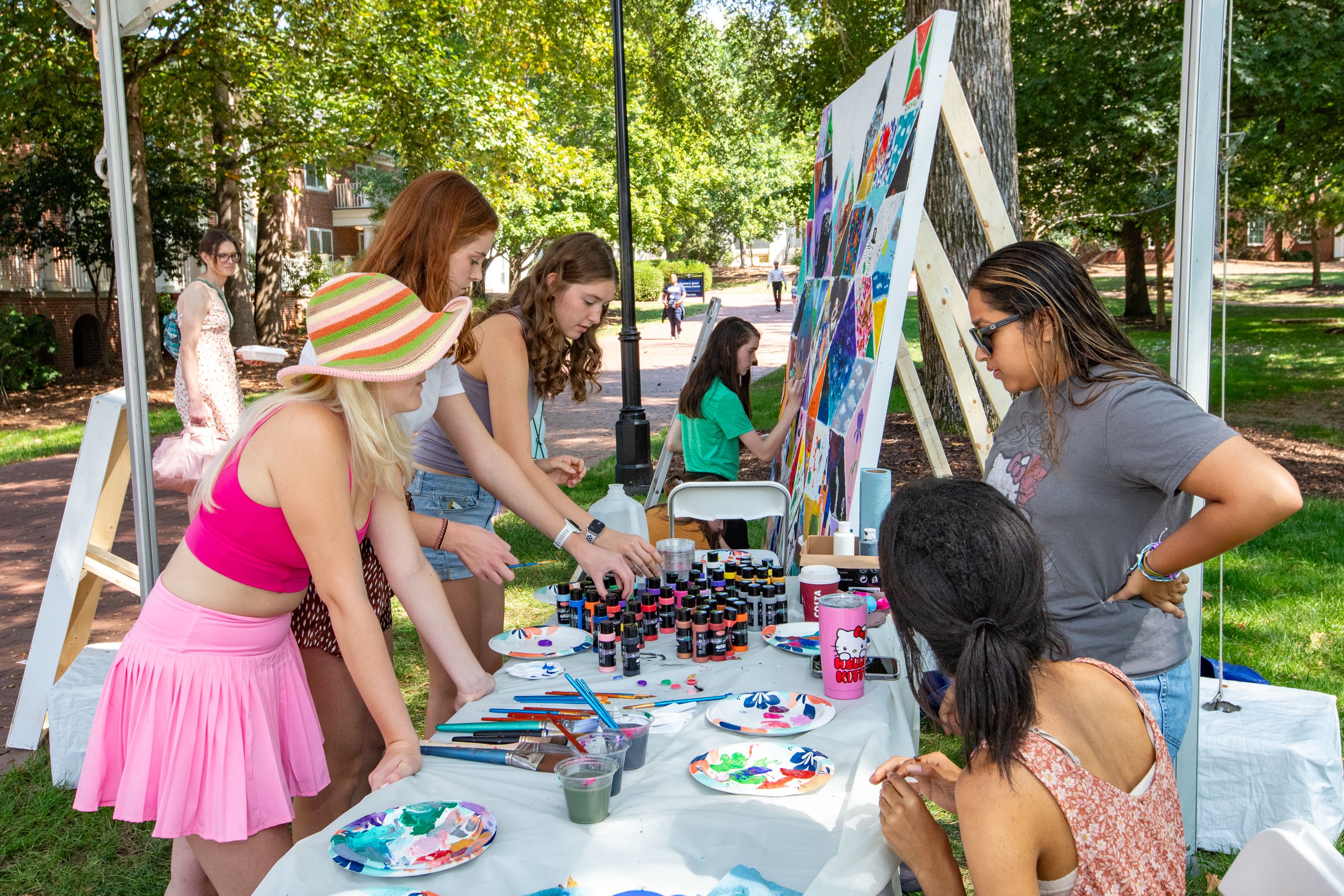 several people participating in group painting project
