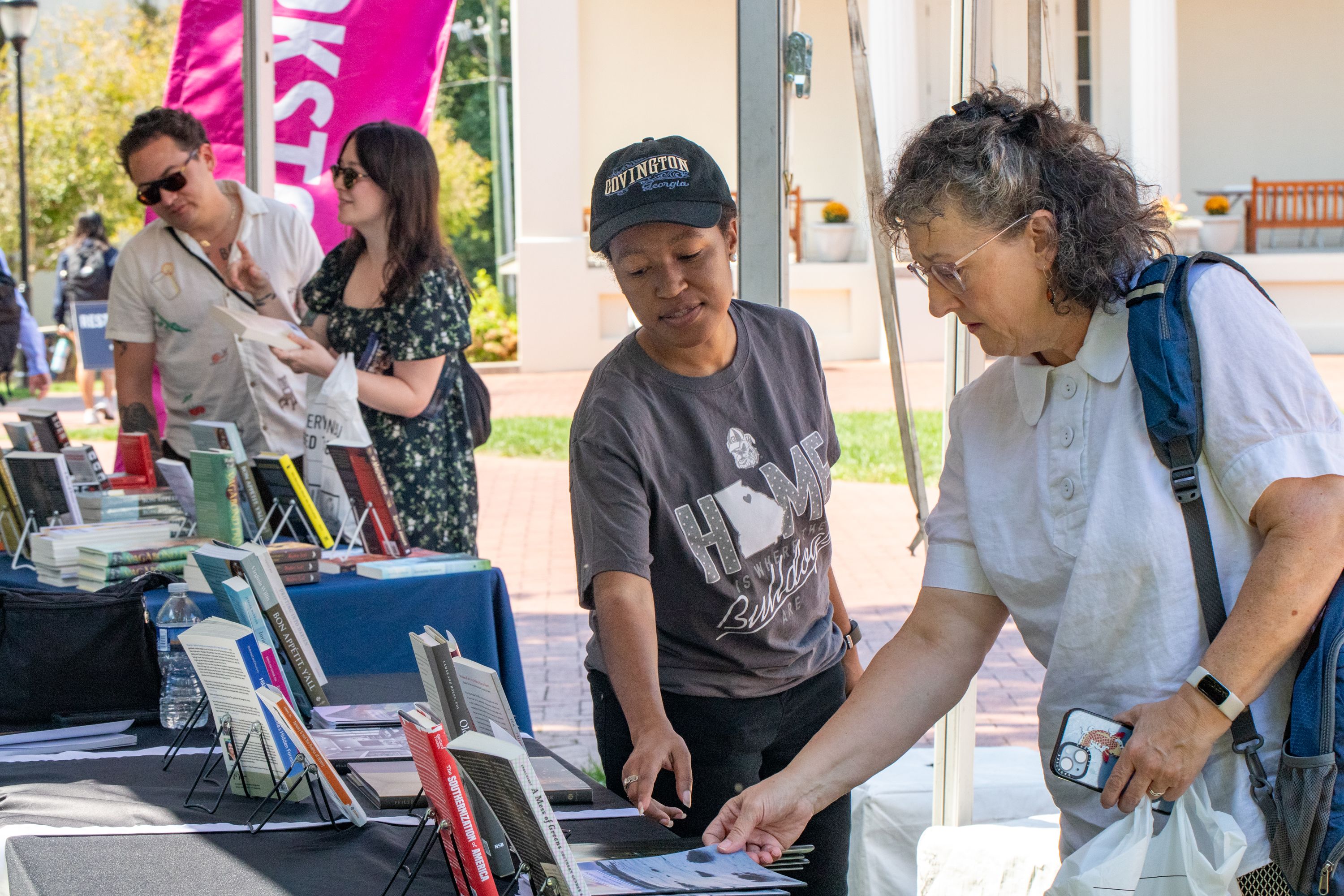Woman reaching for book at festival book tent