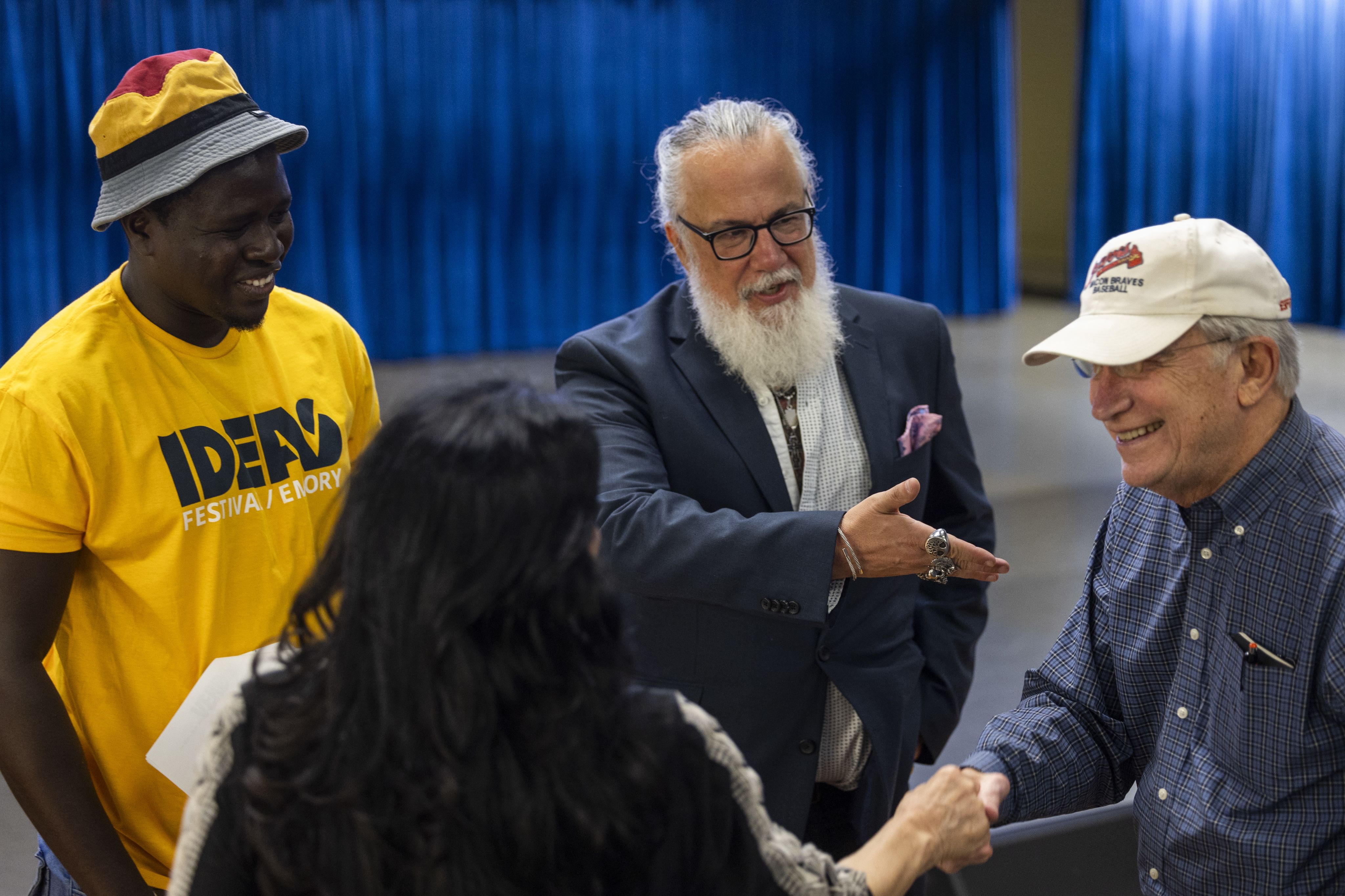 man introducing person in group