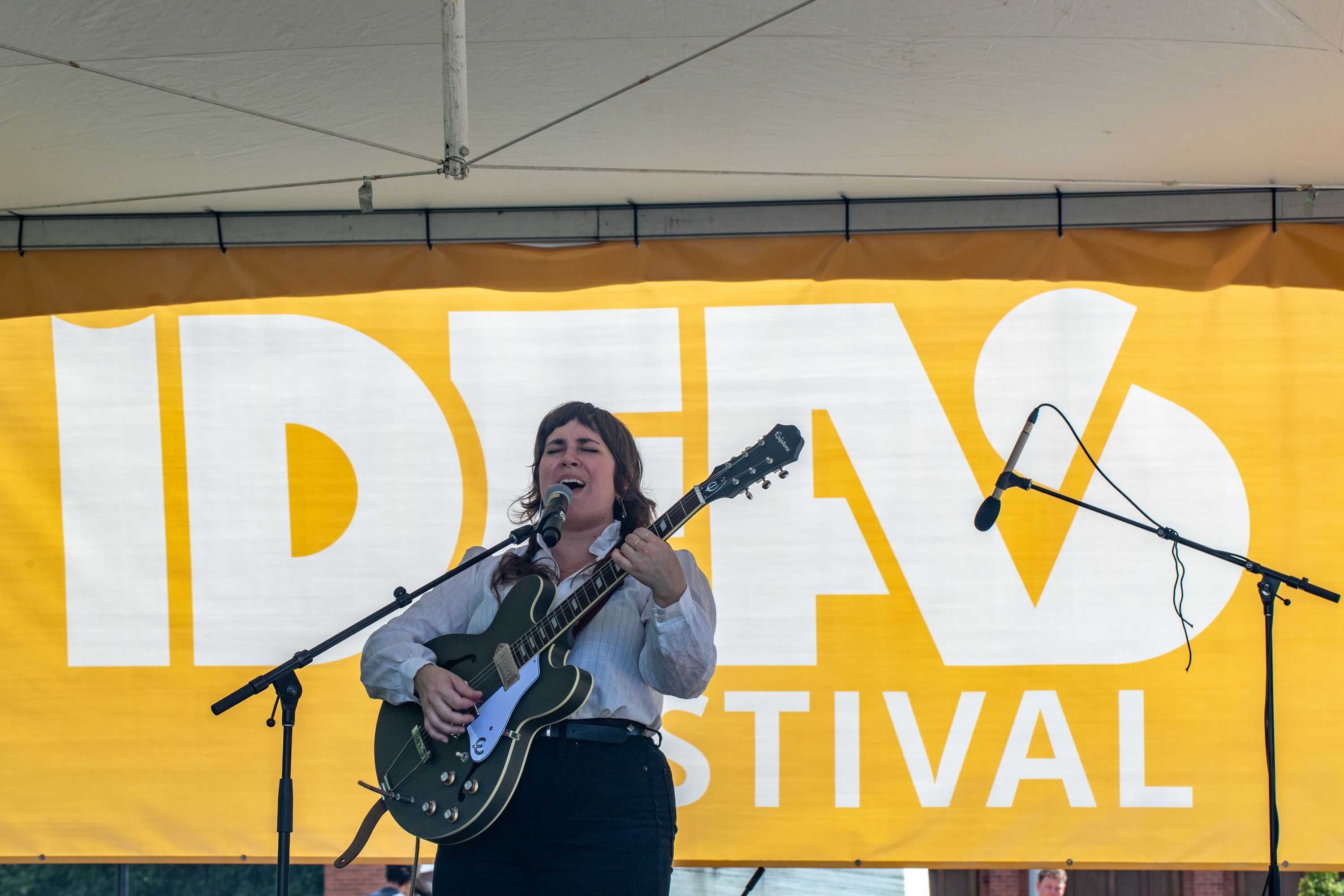 woman singing and playing guitar