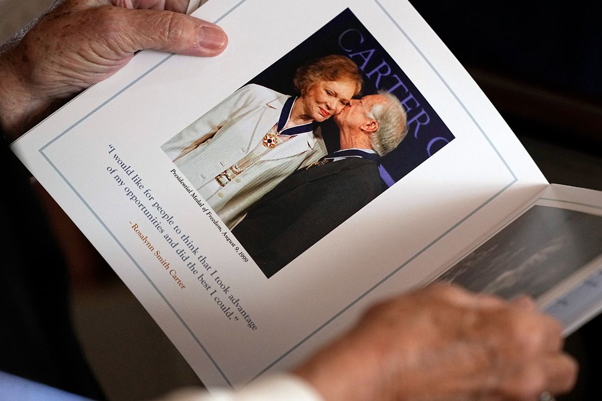 Image of Rosalynn Carter's memorial program. The program includes an image of Jimmy kissing her cheek and reads: "I would like for people to think that I took advantage of my opporunities and did the best I could." The quote is attributed to Rosalynn Smith Carter.