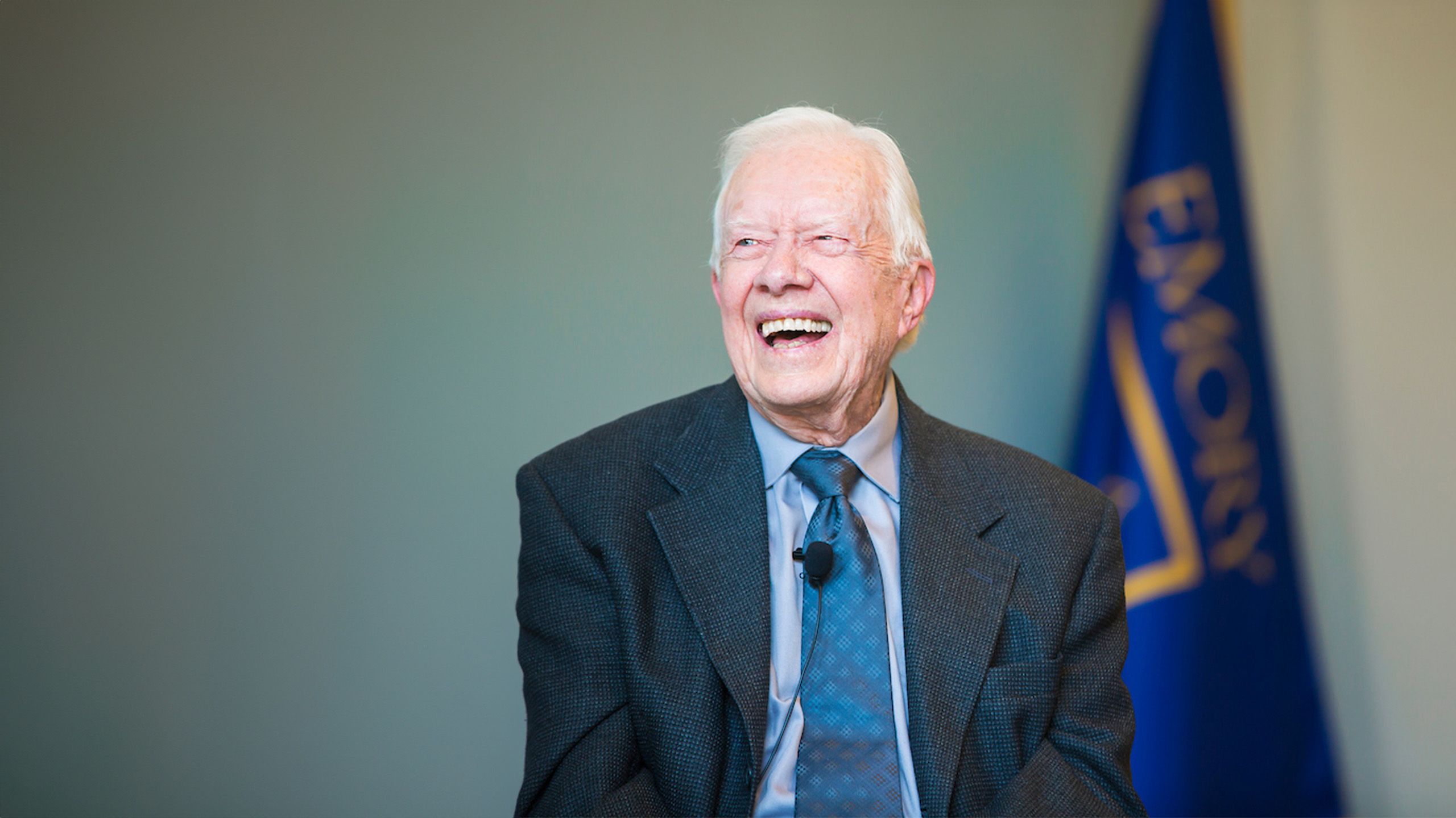 A photo of President Carter with an Emory flag in the background