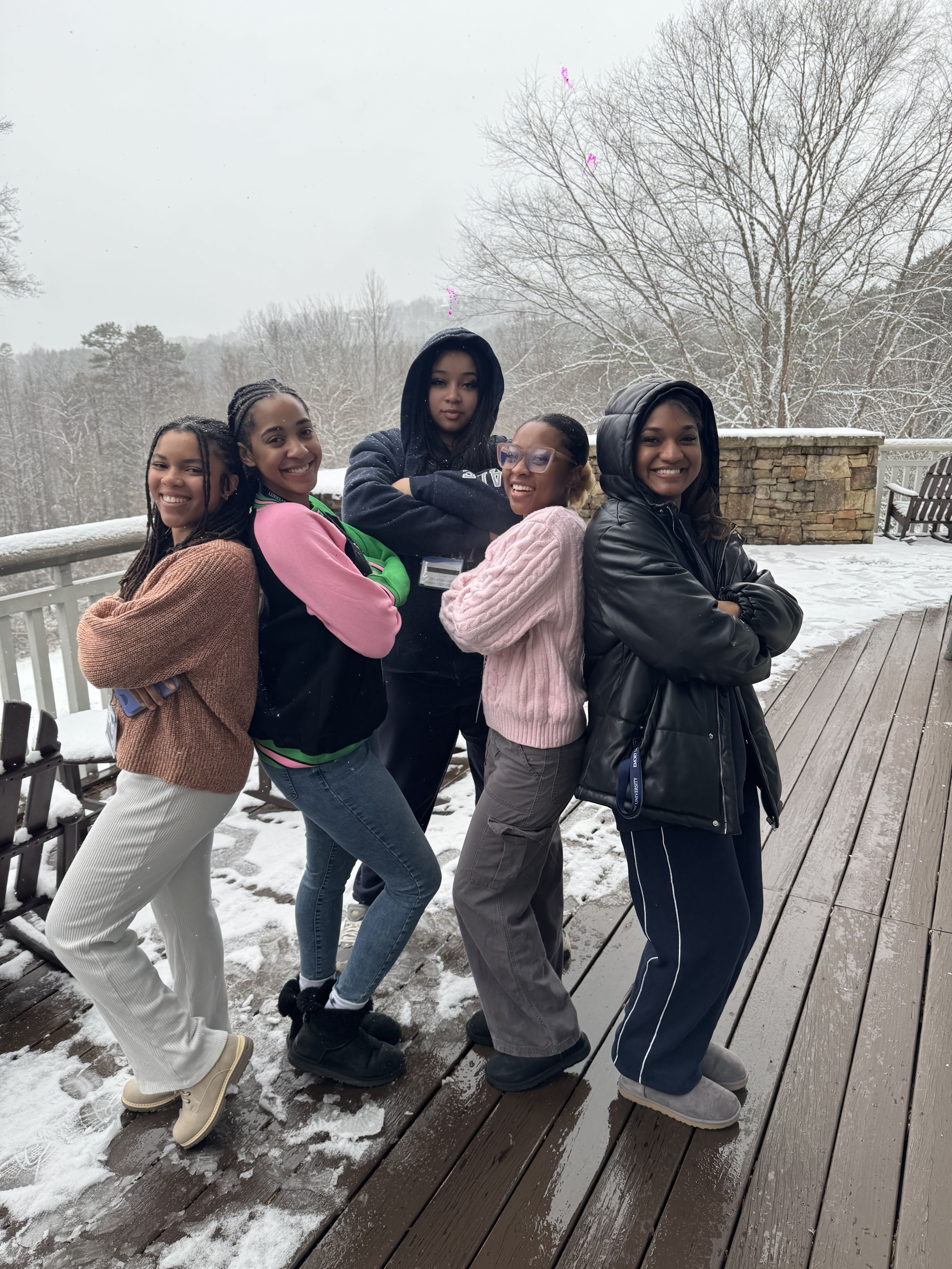 Five MLK scholars posing for picture on deck in snow