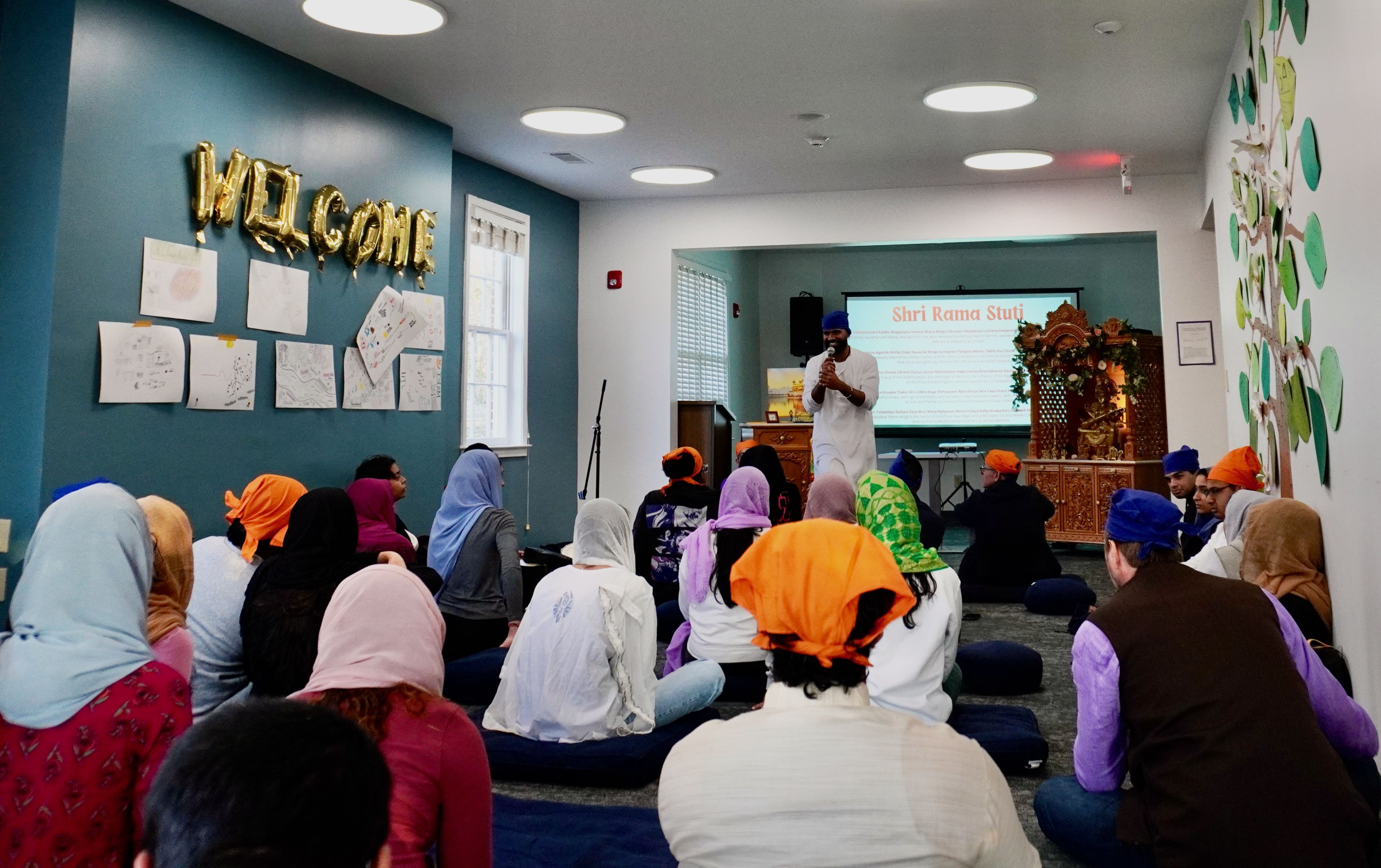 Rajeev Persaud with microphone in front of students