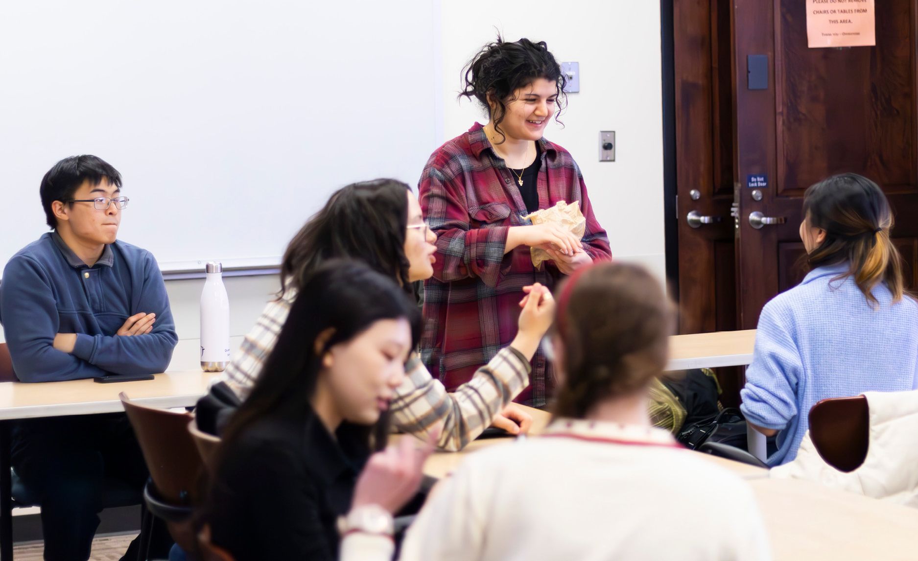 Photo of several Emory students at American Sign Language Club meeting.