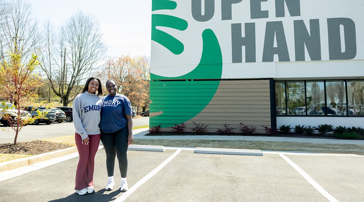 Photo of Nina Selders and classmate in front of Open Hand Atlanta building.