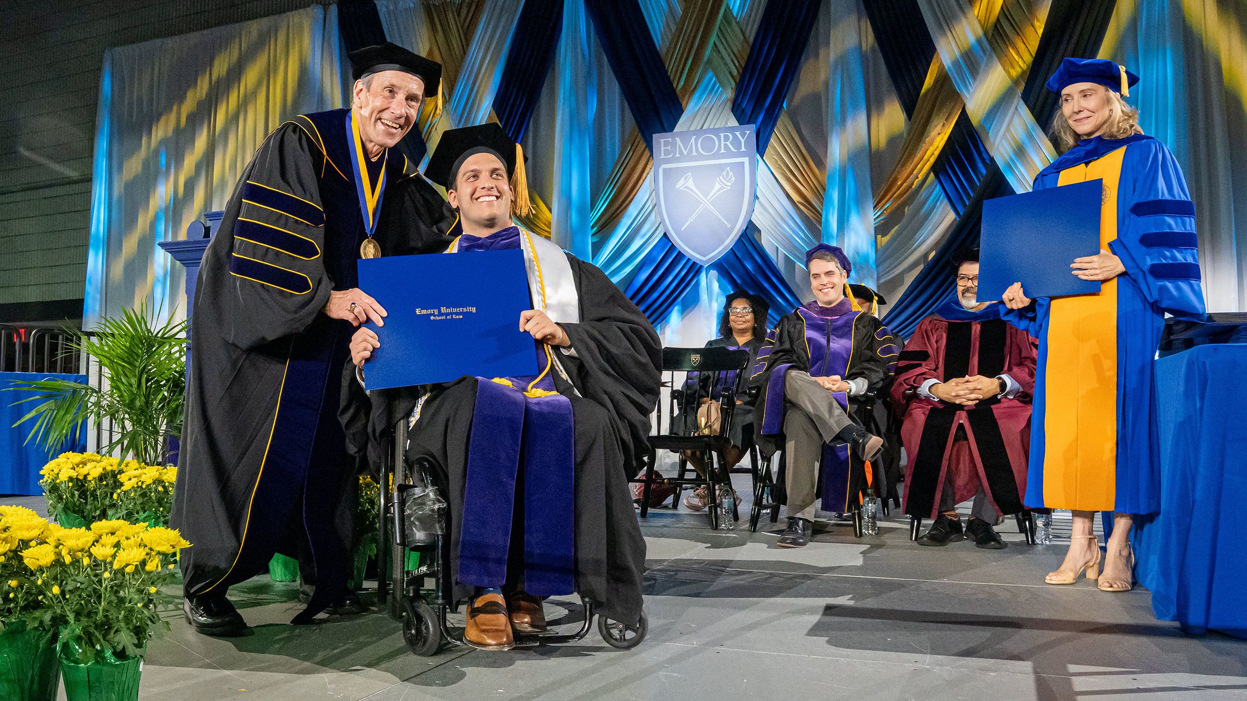 A graduate receives his diploma