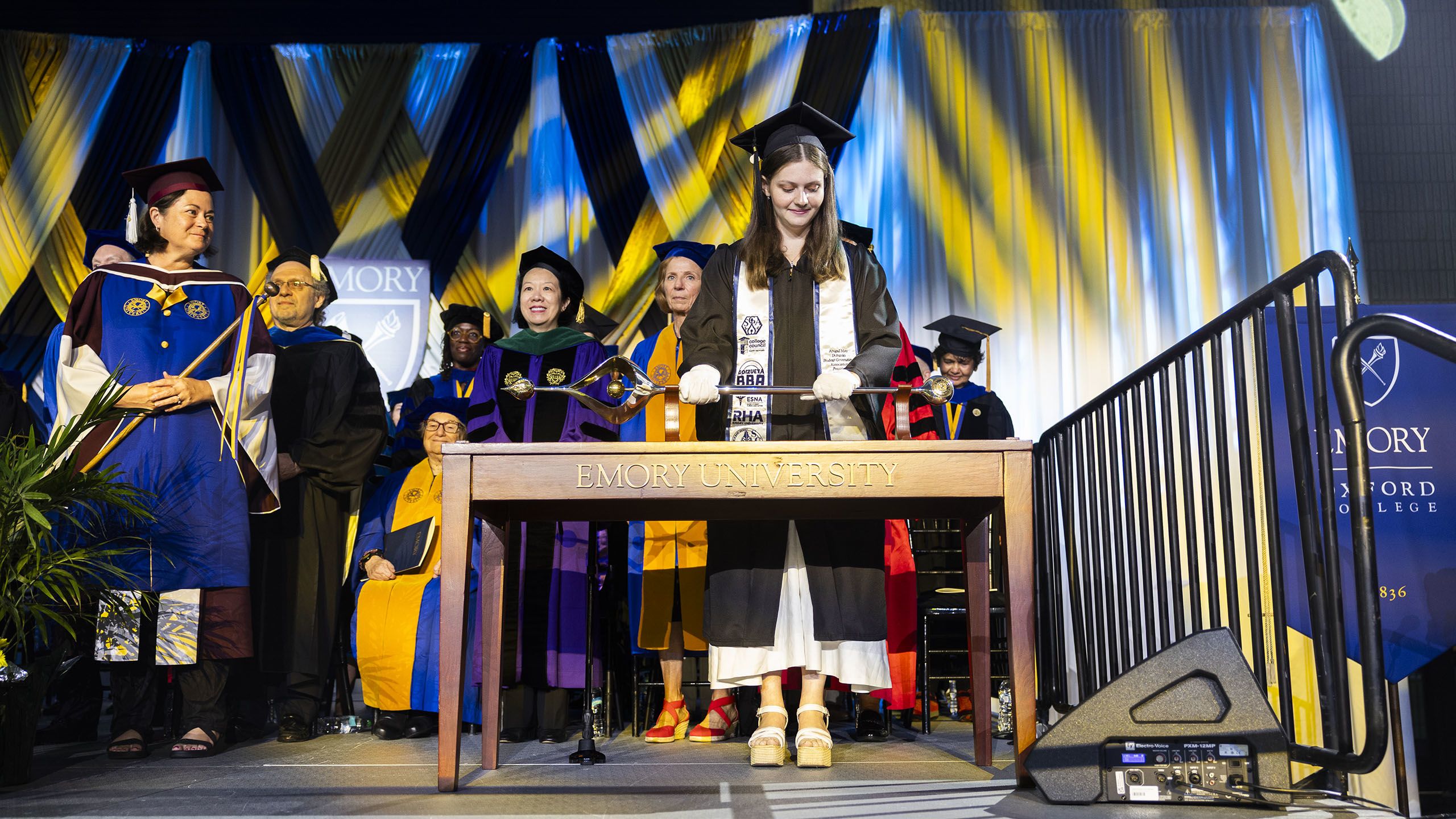 The mace is placed on the podium to start Commencement