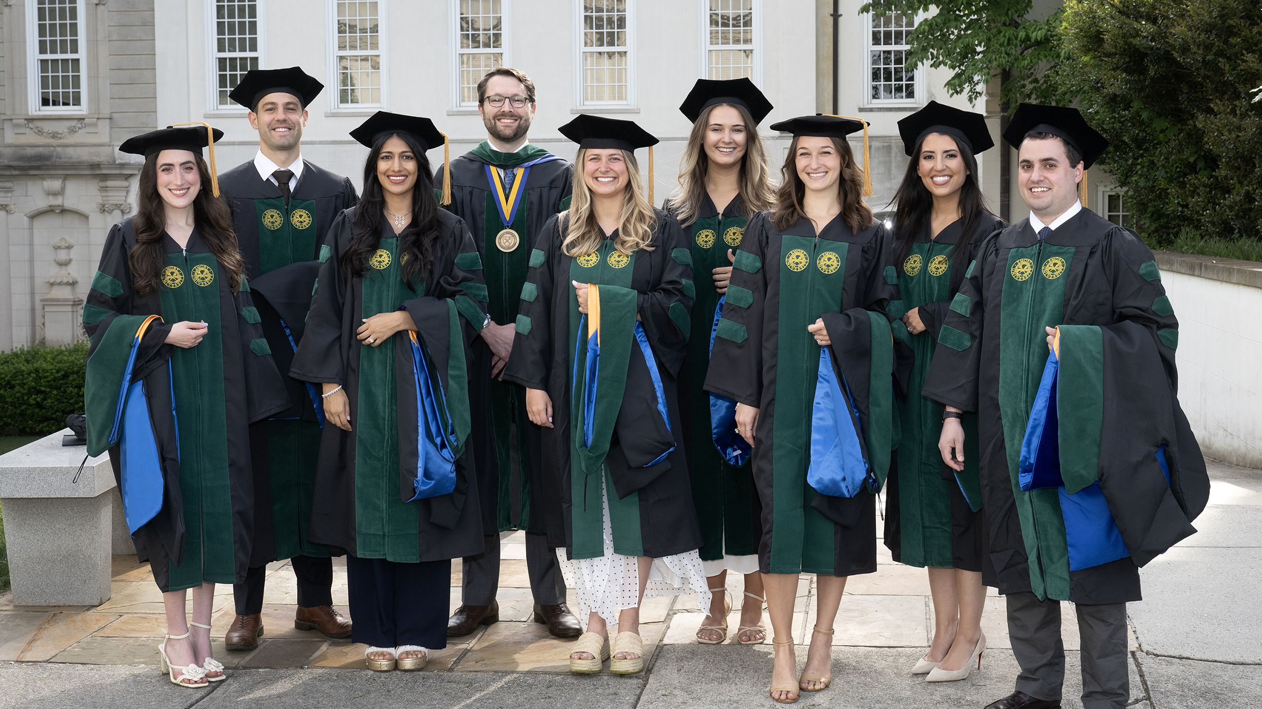 A group of MD graduates pose in academic regalia