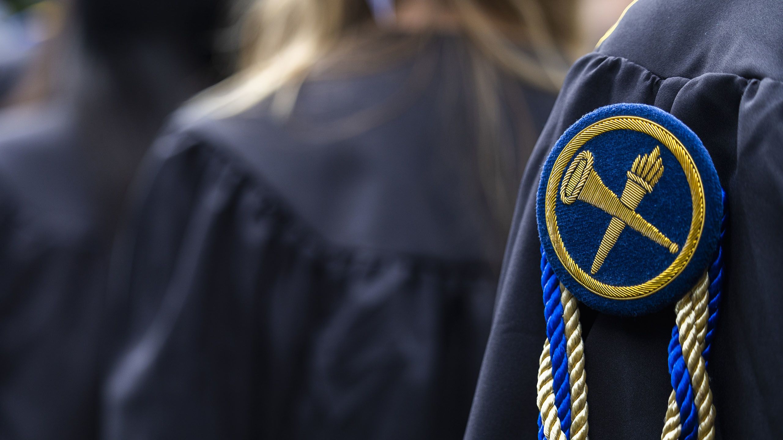 Emory University academic regalia showing the trumpet and torch emblem