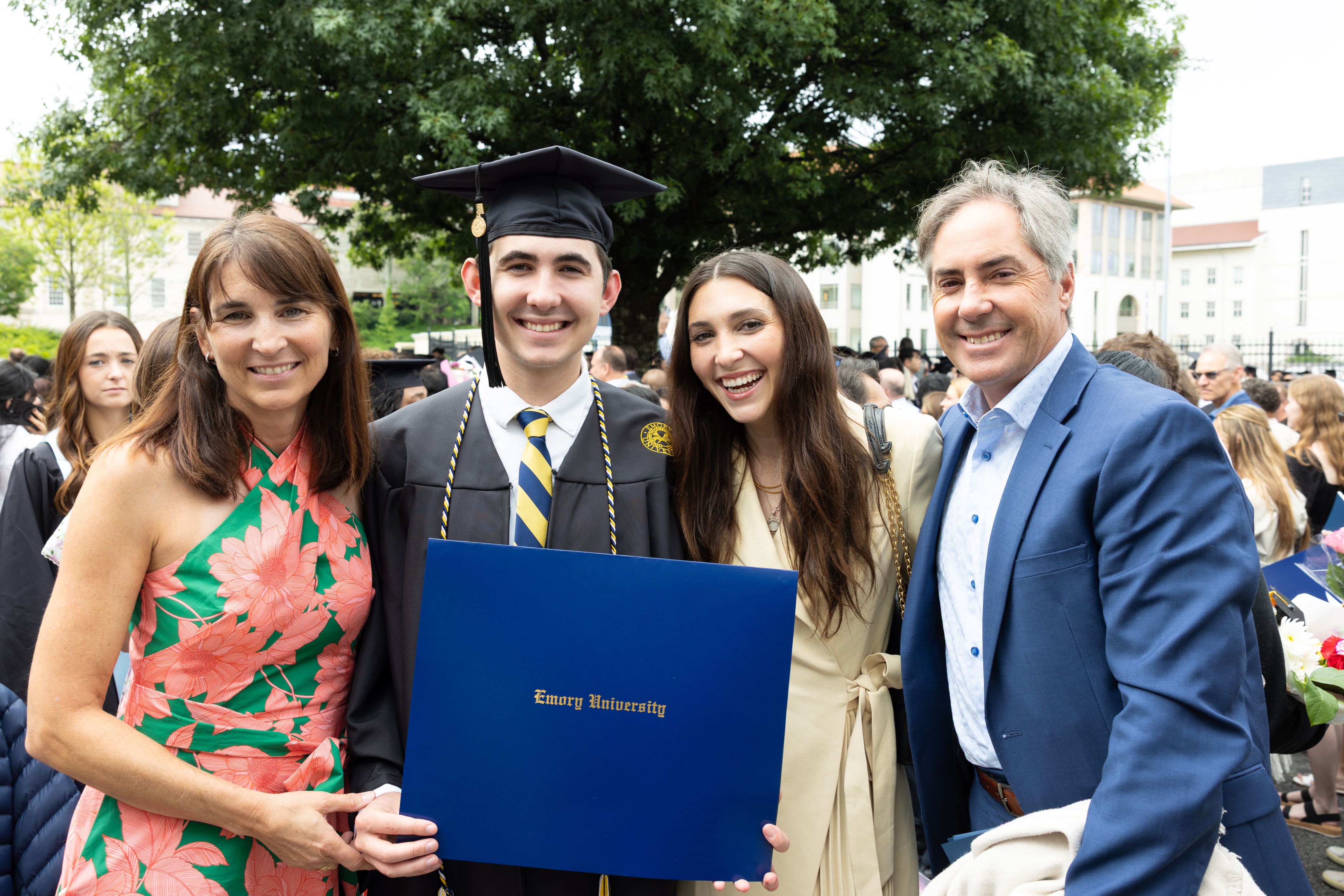 A student poses with his family