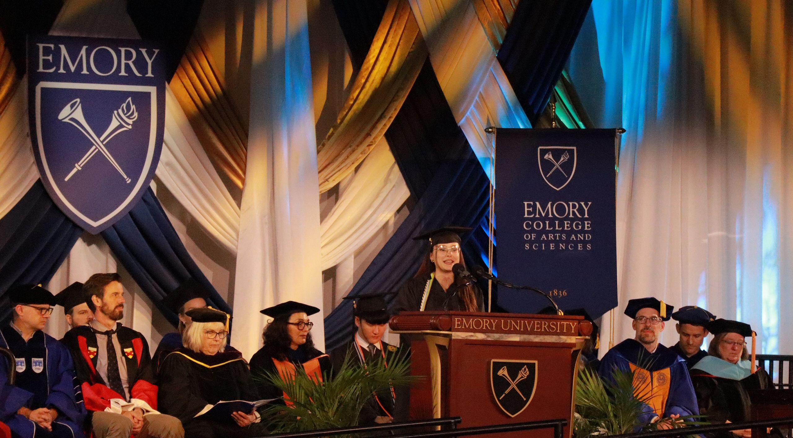 A student speaks from the Commencement stage