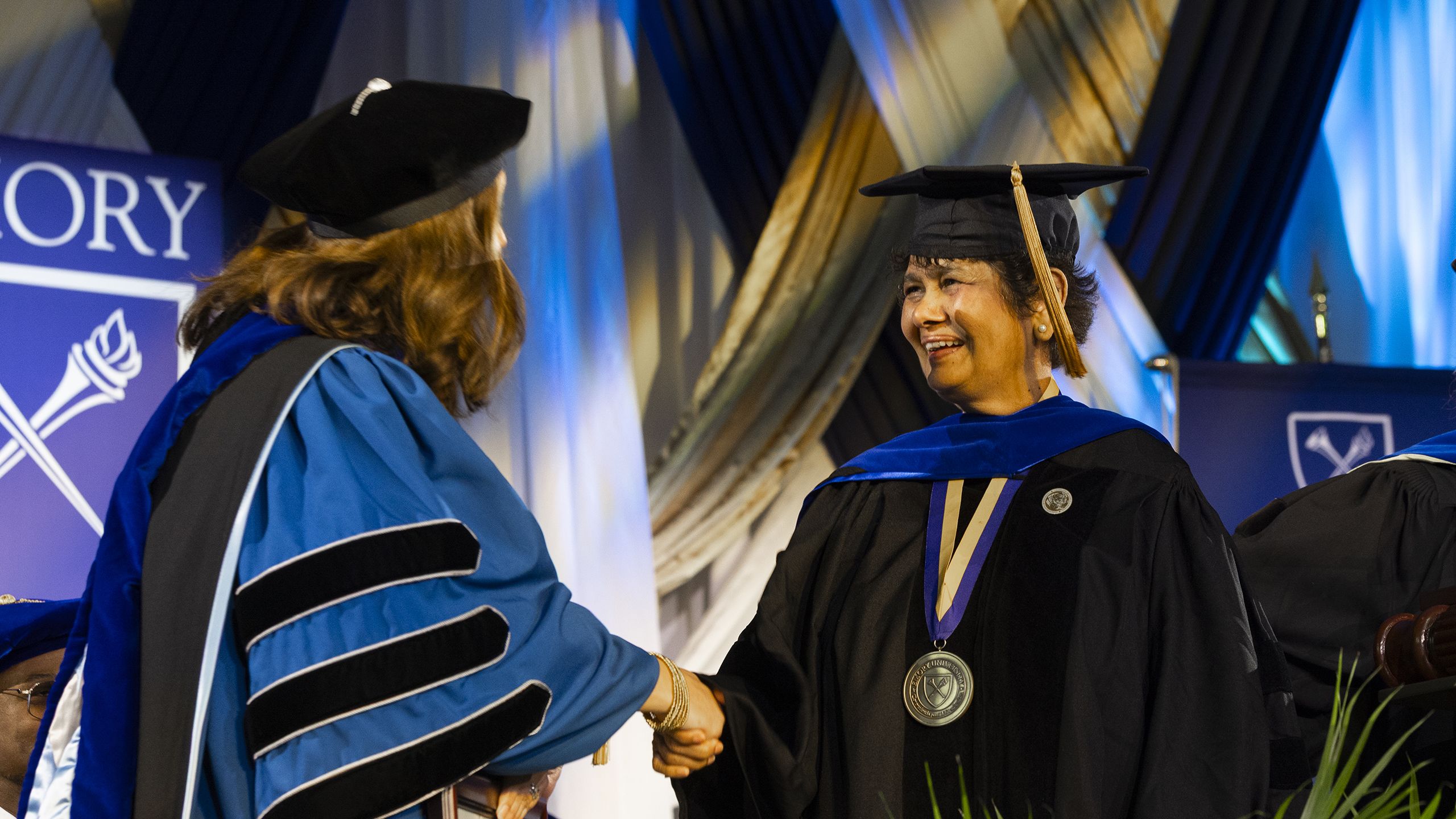 Amita Manatunga shakes hands on stage