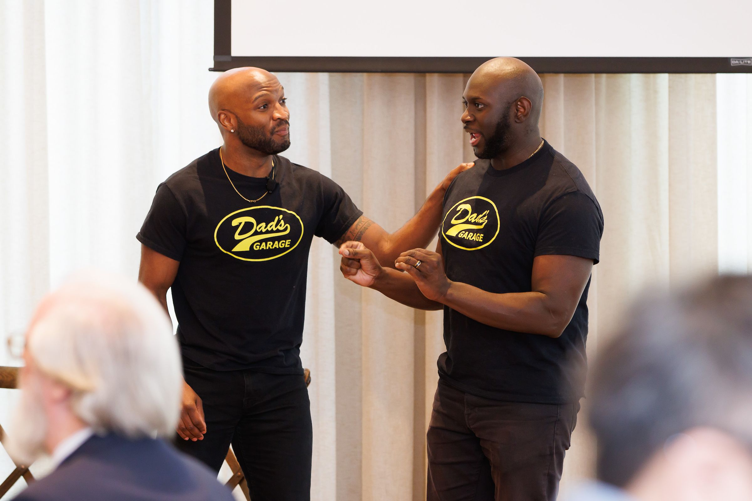 Two men from Dad's Garage improv group performing