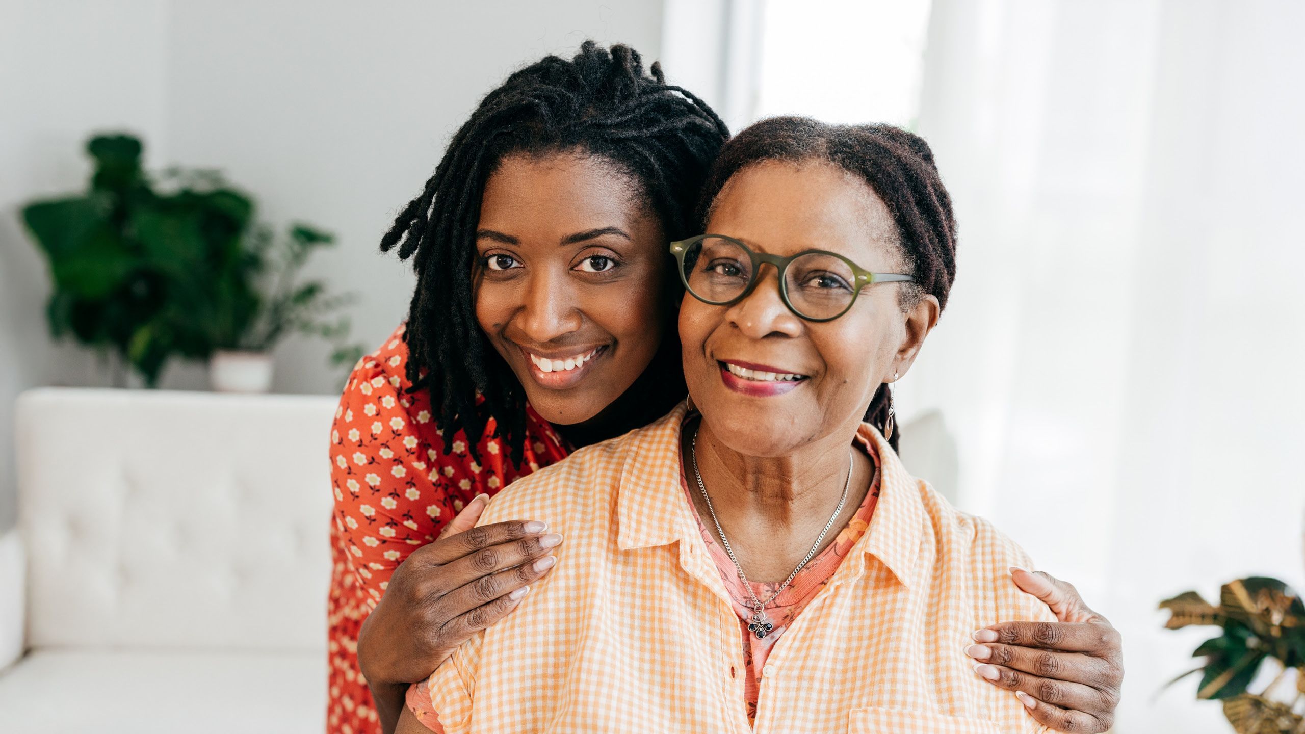 A photo illustration of a smiling younger woman and older woman embracing