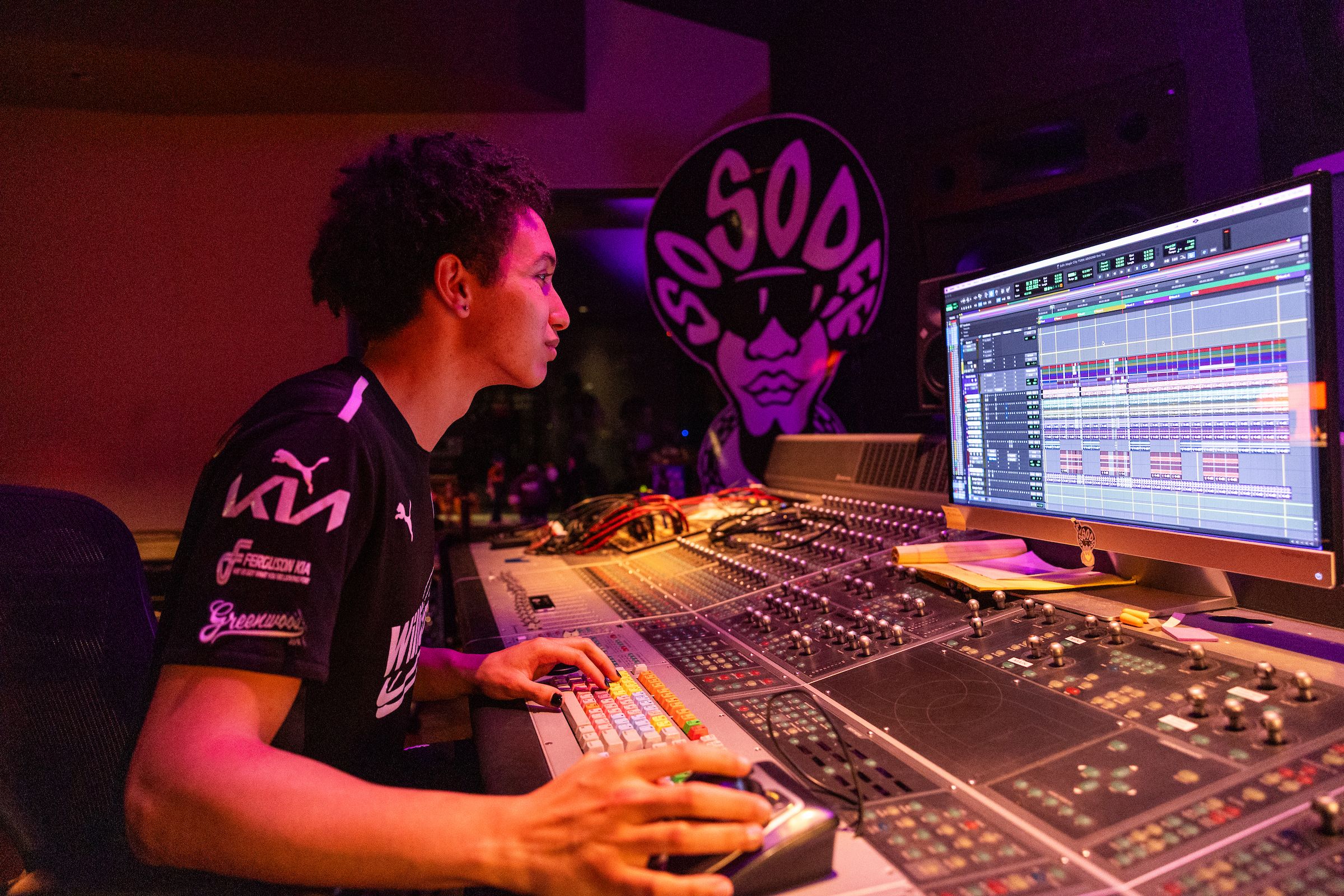 Student intern at mixing board in studio