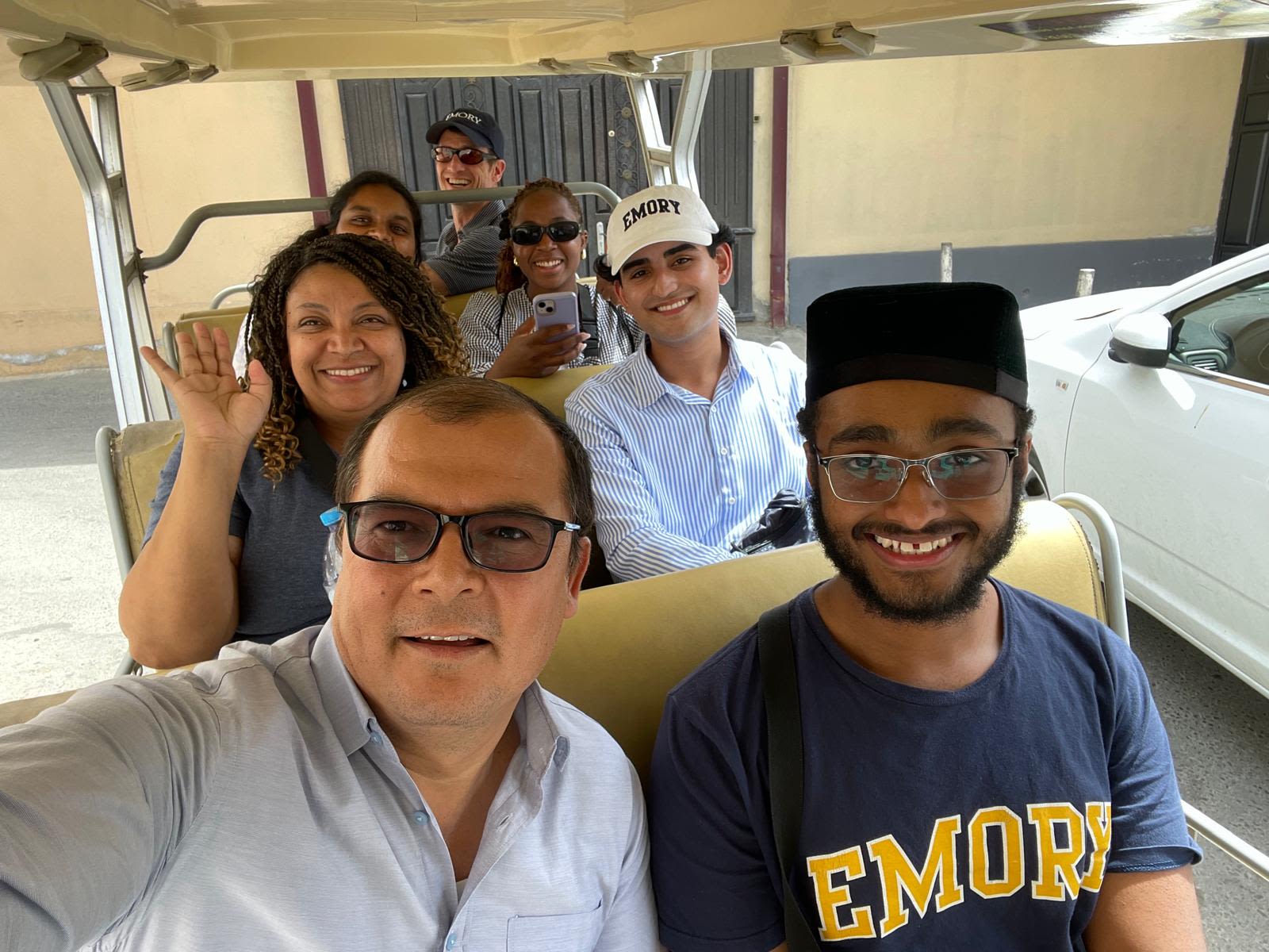 trip leaders and students selfie on golf cart