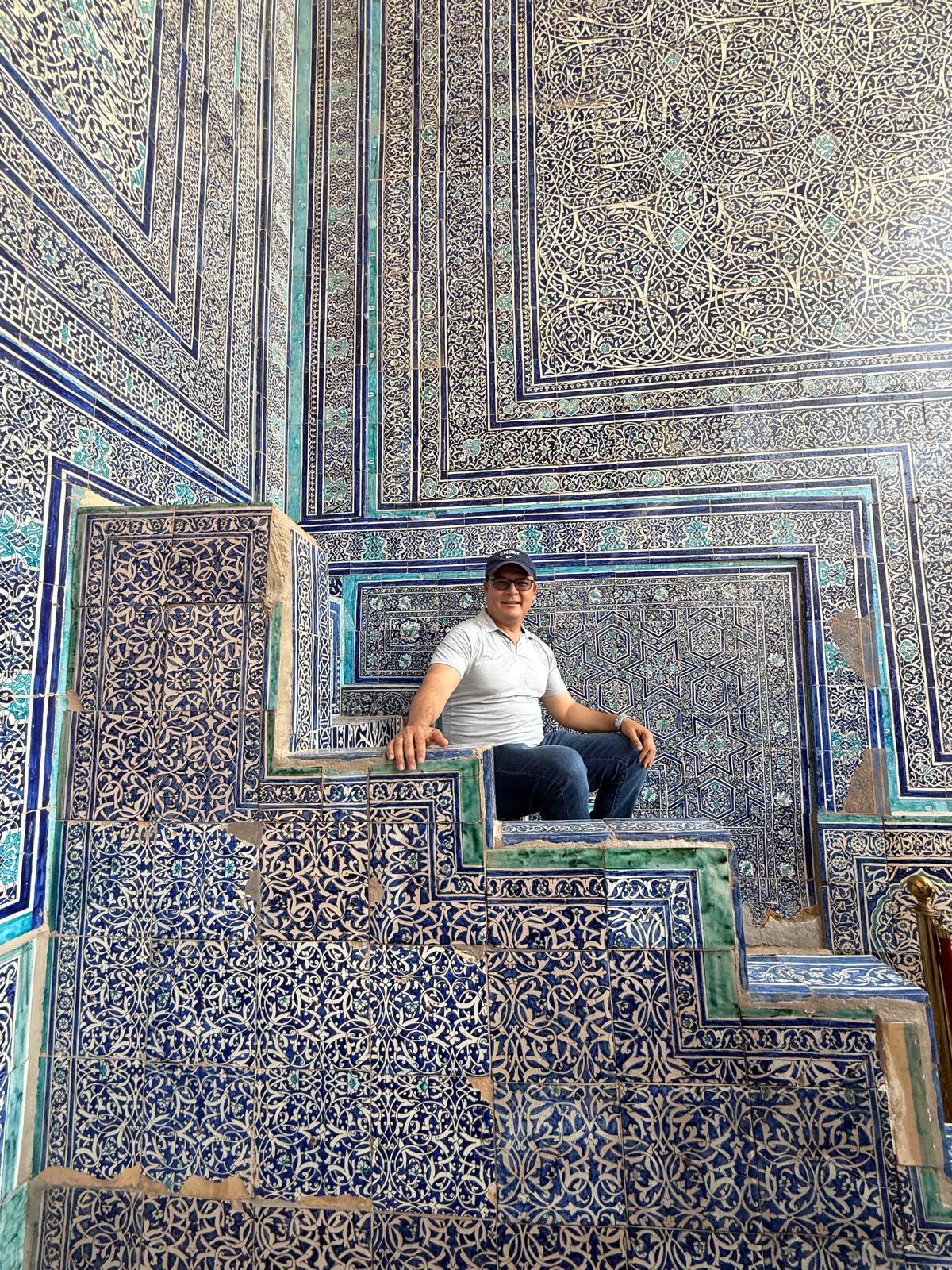 Abdugafurov sitting on blue-tiled steps