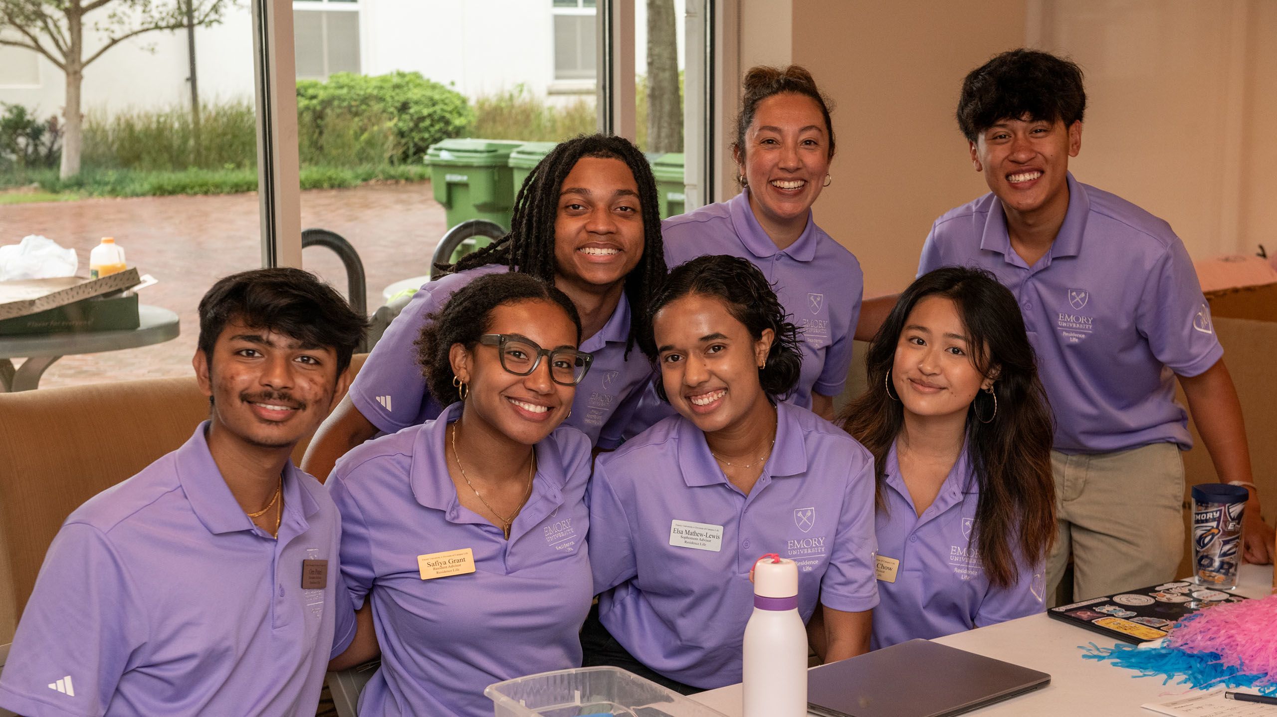 Group of student ovlunteers in matching lilac polos