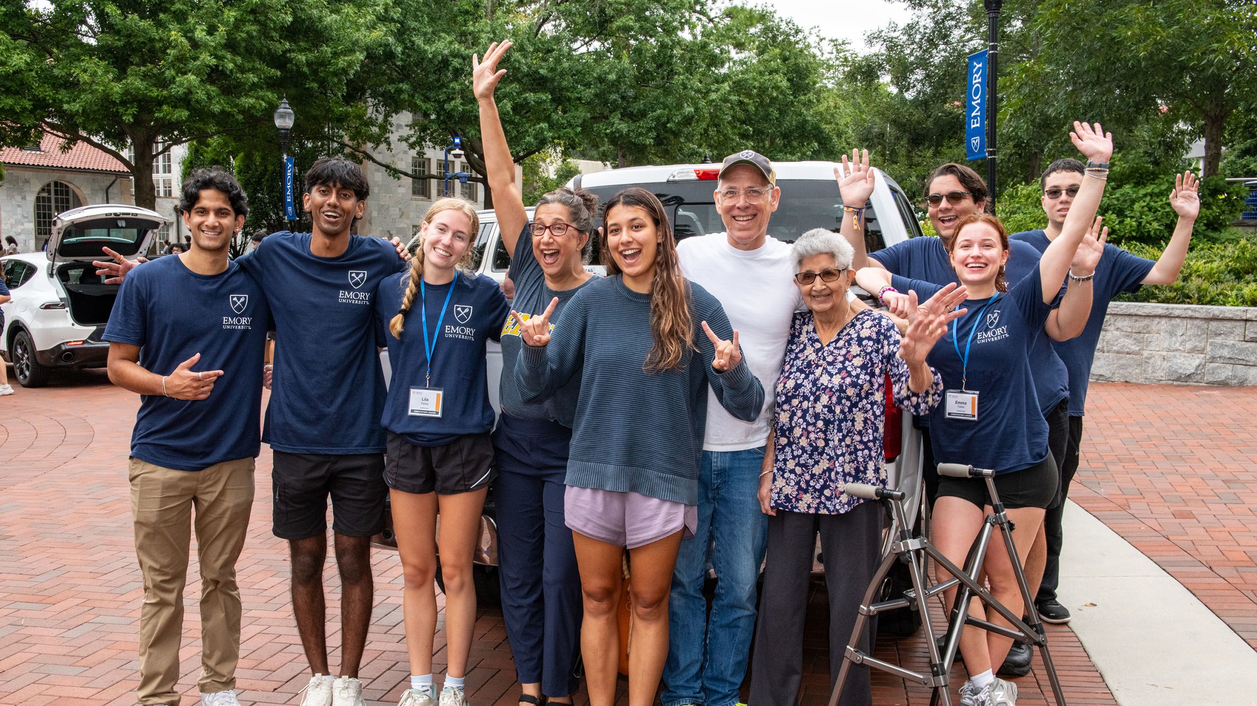 A multigenerational photo with a new student, her family, and several orientation leaders