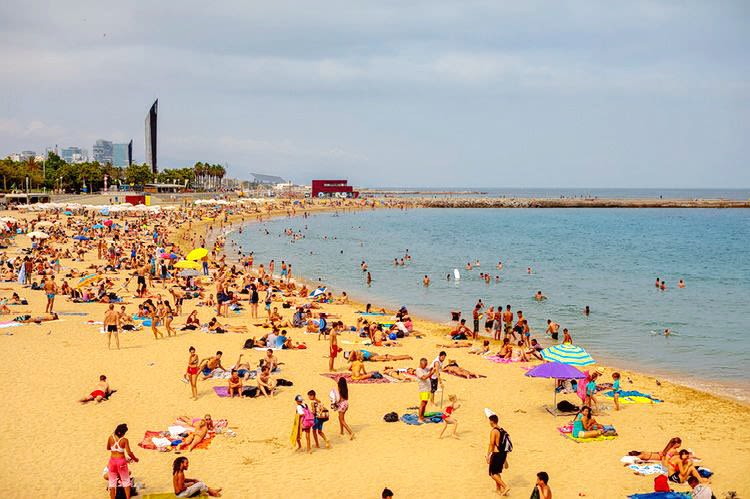 Sun seekers on a beach in Barcelona