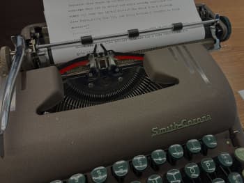 A Smith-Corona typewriter loaded with a sheet of paper